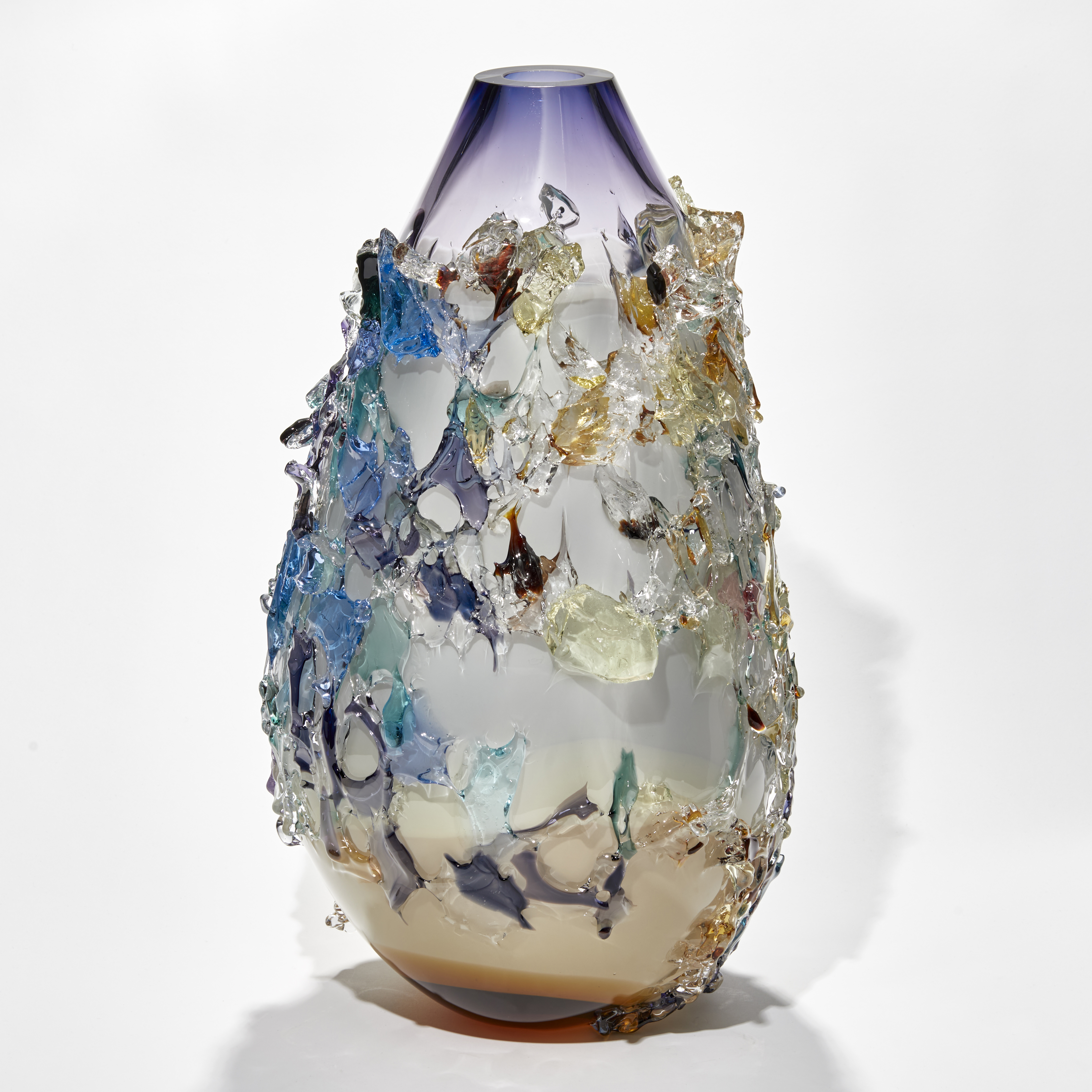 elongated organic teardrop shaped vessel in light apricot white and rich purple with exterior patchy texture in differing colours handmade from glass