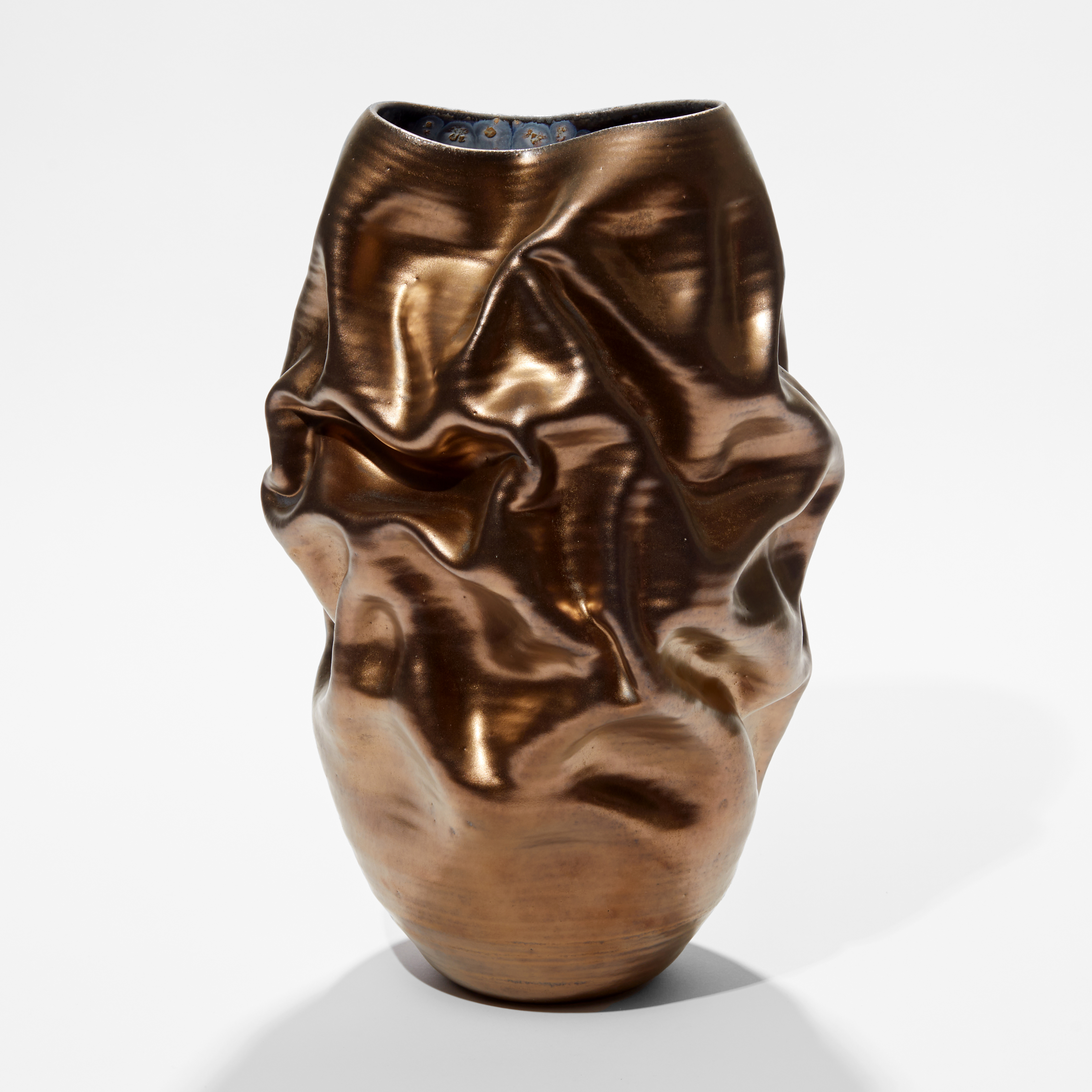 ceramic tall stain gold ridged and wrinkled vessel with crumpled surface hand made and thrown from clay