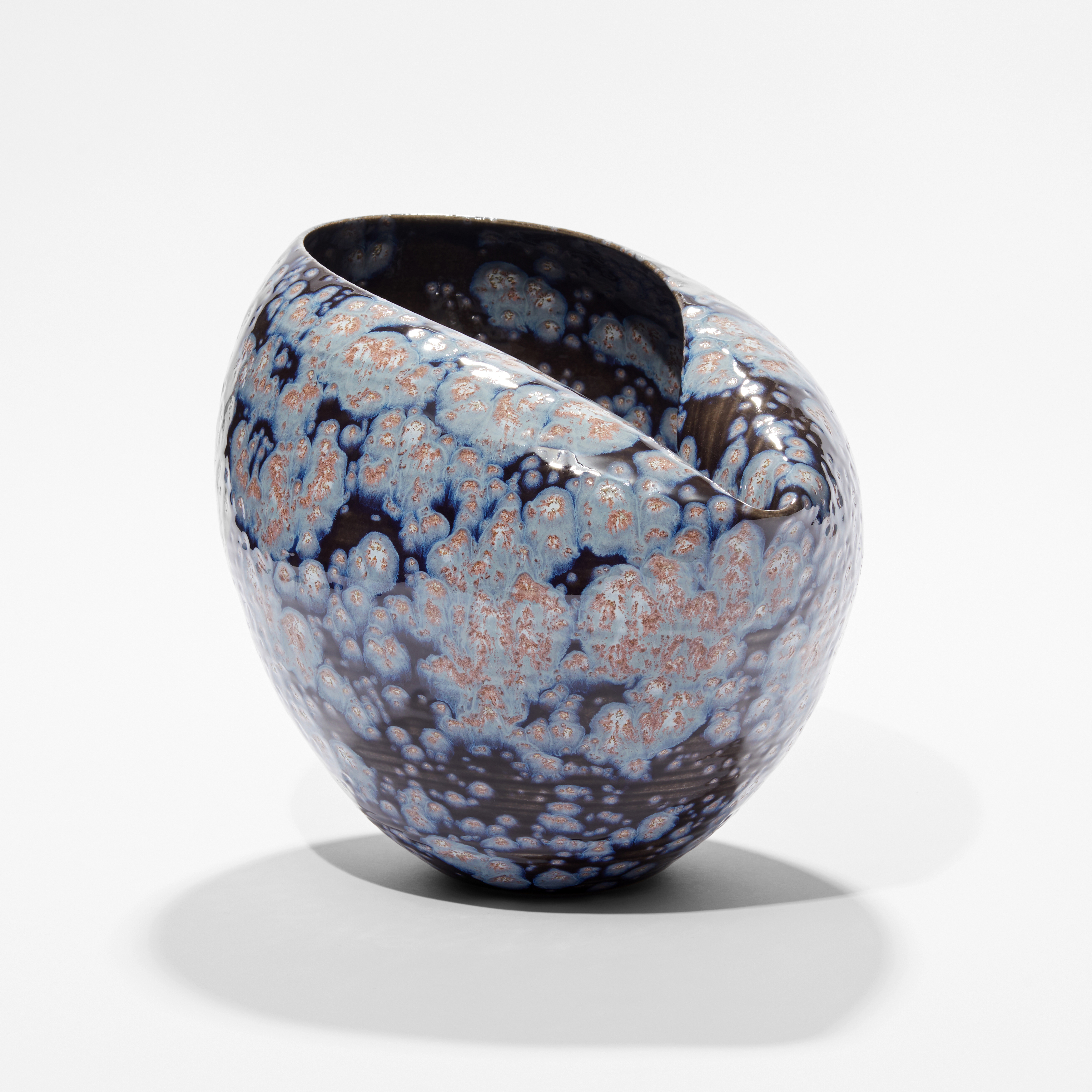 rounded vase with collapsed inverted top section in dark black blue with light blue white and pink starburst splodges hand thrown and glazed from ceramic