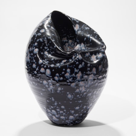 black blue with light blue splodges tapered based rounded vessel with wrinkled lightly collapsed side and opening hand made from ceramic