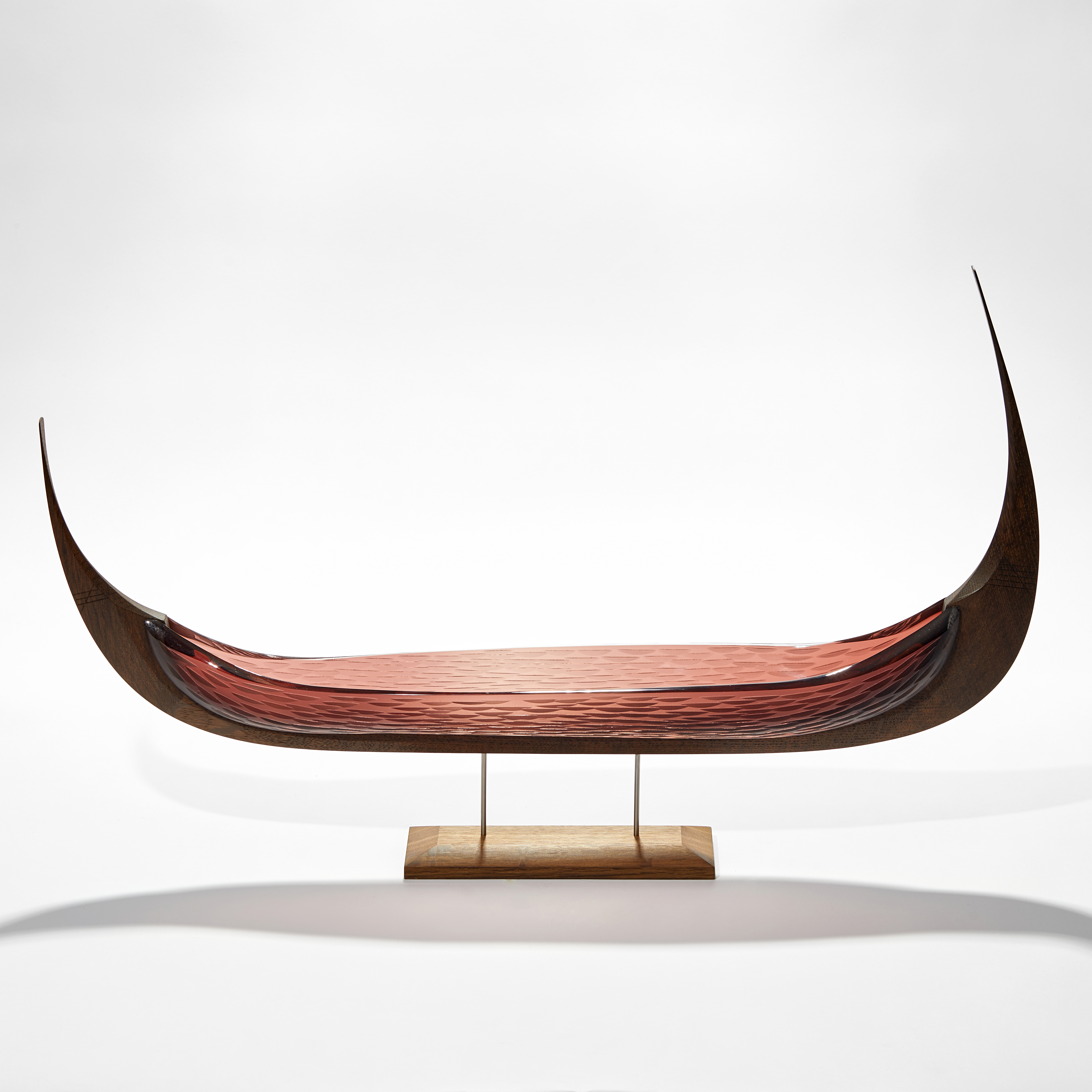 viking ship with oak keel with carved detail and aubergine tea coloured glass hull with cut texture raised on a simple two steel pinned base in wood hand made 