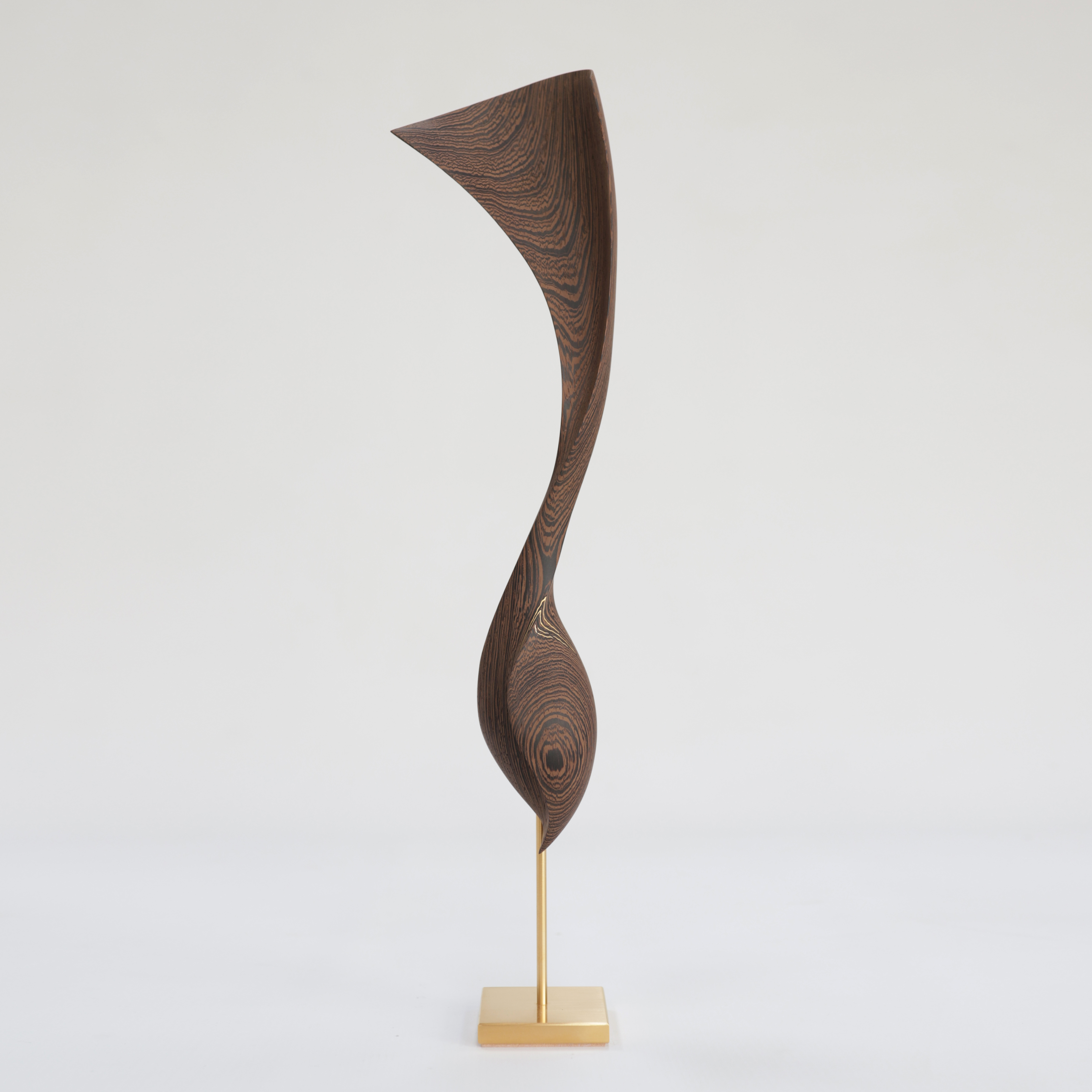 curled wooden sculpture created from Wengé with gold inlaid detail and a flared fan shaped top long slender neck and round base perched on a gold plated stainless steel base
