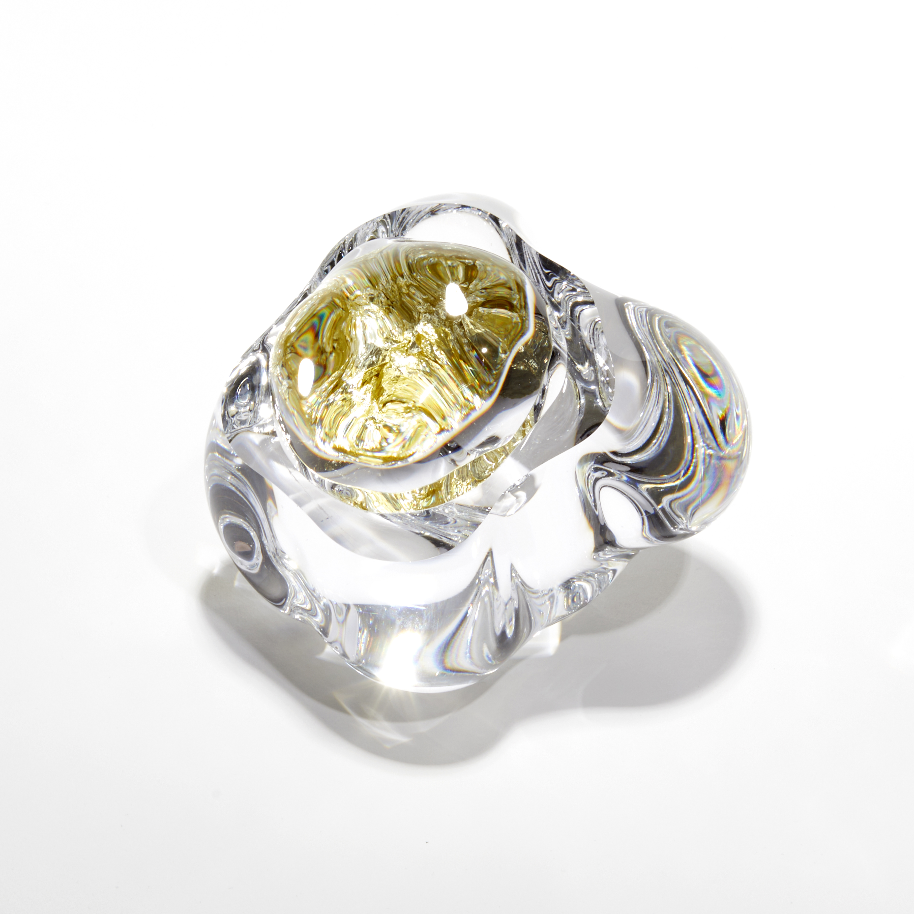 clear globule with interior filled with gold leaf the exterior acts as a lens distorting the view of the contents hand made from glass