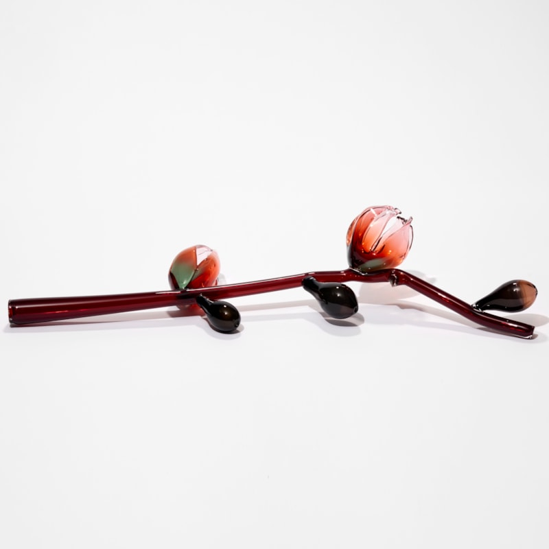 prone oxblood red stem with abstract flowers and buds in pink red and celadon hand made from sculpted glass