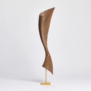 flared dynamic abstract wooden sculpture with gold inlaid in the grain perched on a gold plated stainless steel base