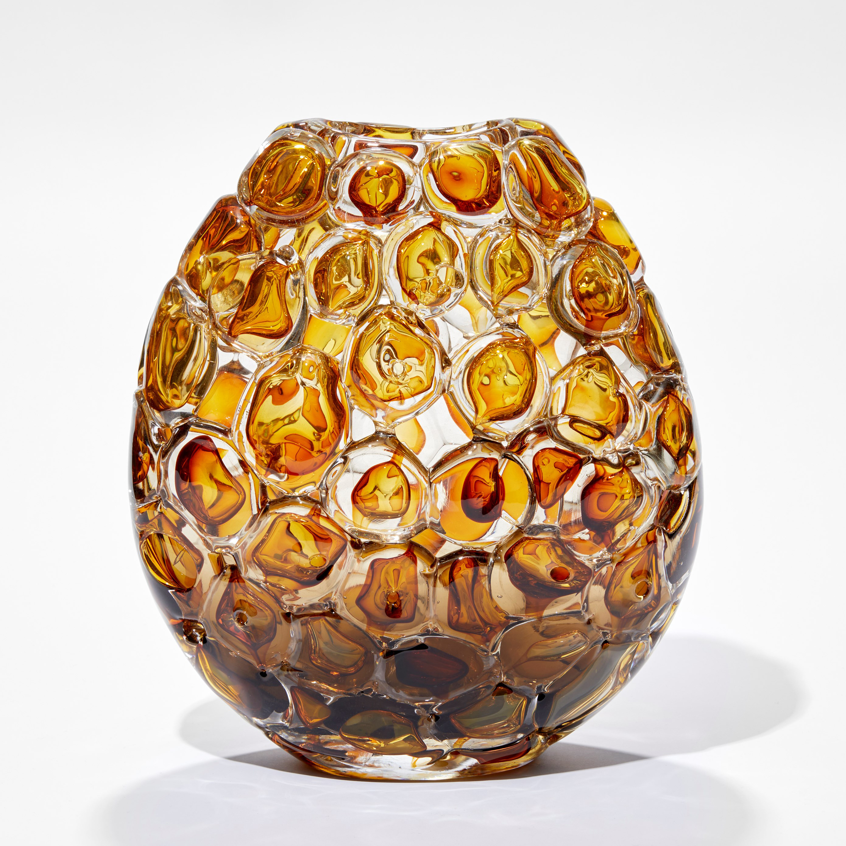 oval vase in rich amber and clear glass with the outside covered in oversized bubbles with the appearance of bubblewrap hand blown from glass