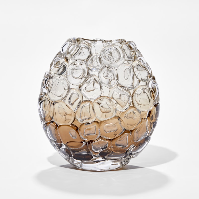small oval hand blown glass vase covered in oversized bubbled with transparent top fading to fawn and dark brown