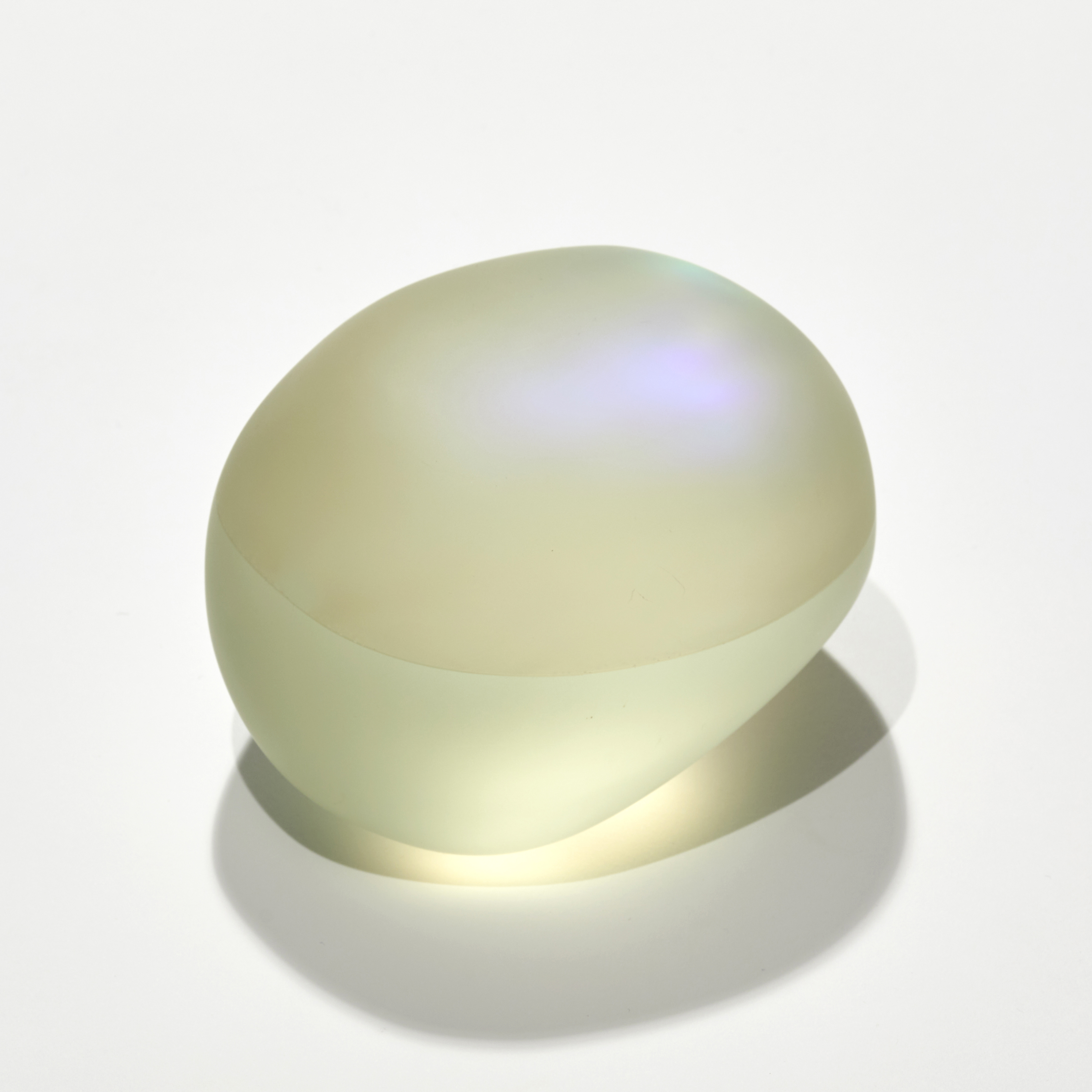 satin smooth finished soft yellow pebble with inner colours glowing outwards hand made and sculpted from cast glass