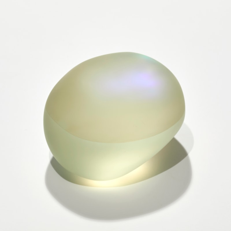 satin smooth finished soft yellow pebble with inner colours glowing outwards hand made and sculpted from cast glass