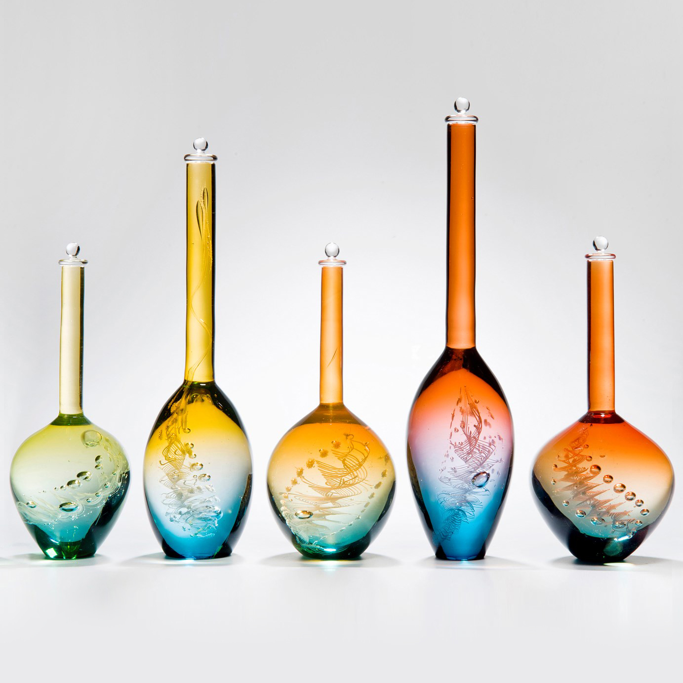 series of five blue art glass bottle sculptures