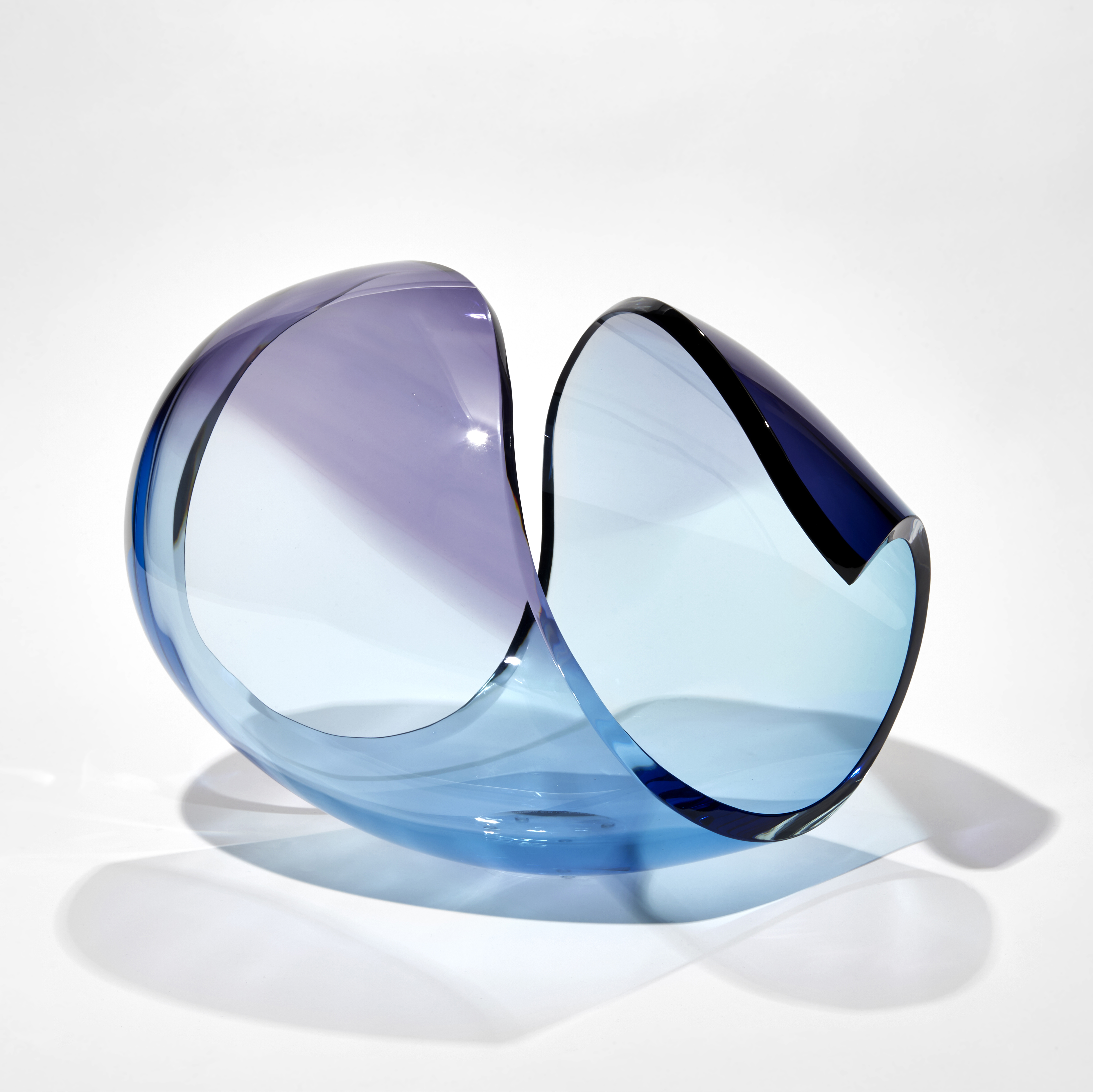 transparent curled glass sculpture in the form of a stylised shell in turquoise and purple hand made from glass