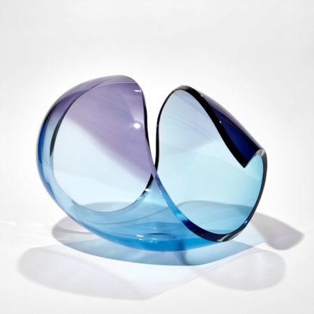 transparent curled glass sculpture in the form of a stylised shell in turquoise and purple hand made from glass