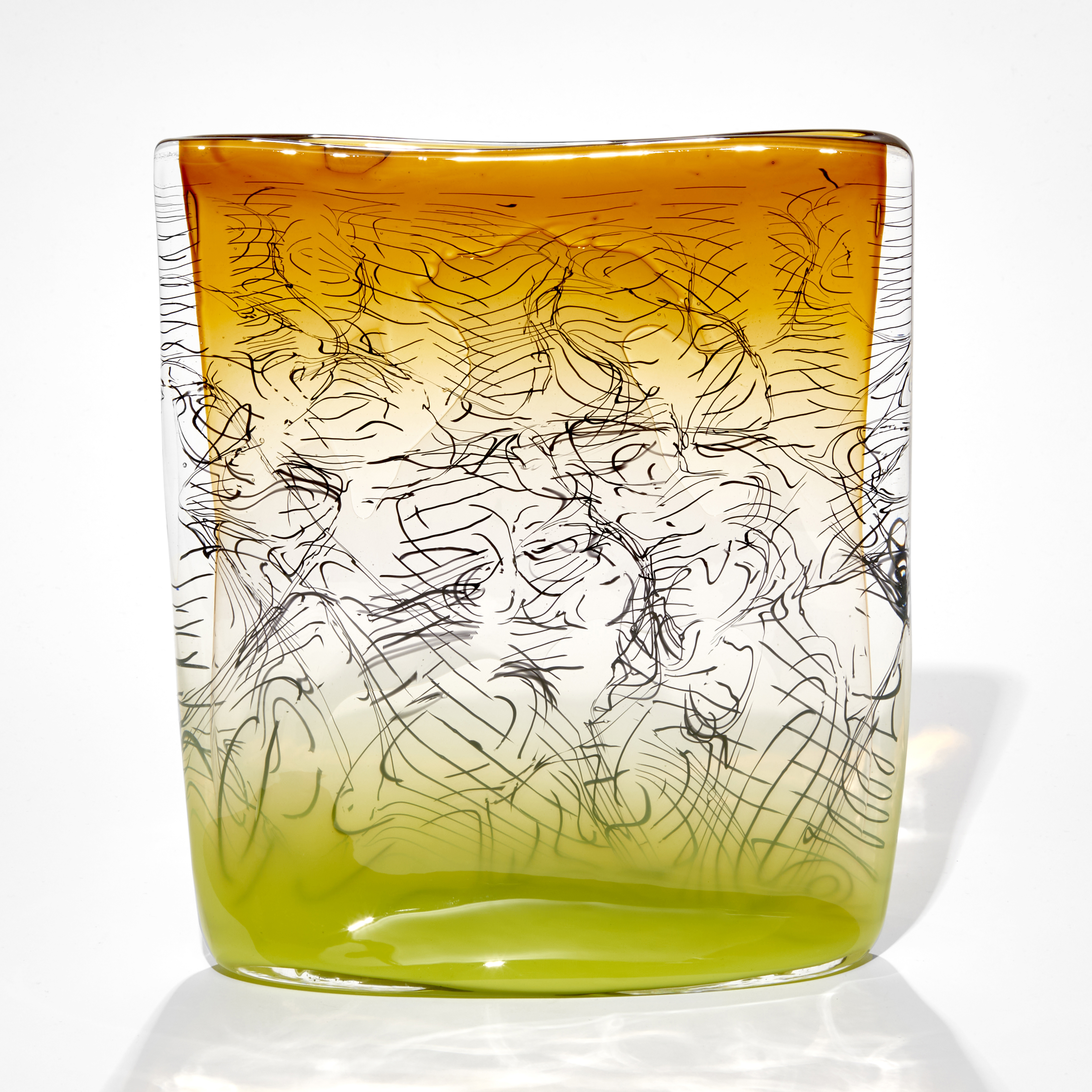 square sculpture with lime base fading to clear then ochre amber yellow with trapped black lines hand made from glass