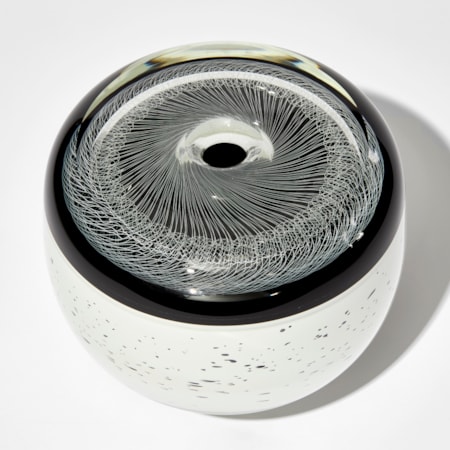 monochrome artwork with spirograph style pattern on the top and white base speckled with black hand made from glass