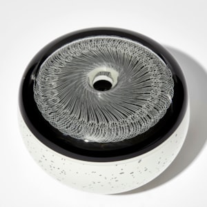 two tone black and white artwork with speckled base and black top with incased filigree lace like design hand made from glass