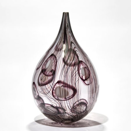 transparent grey and aubergine teardrop shaped vessel with fine lines and abstract circle patterns in dark aubergine handmade from glass