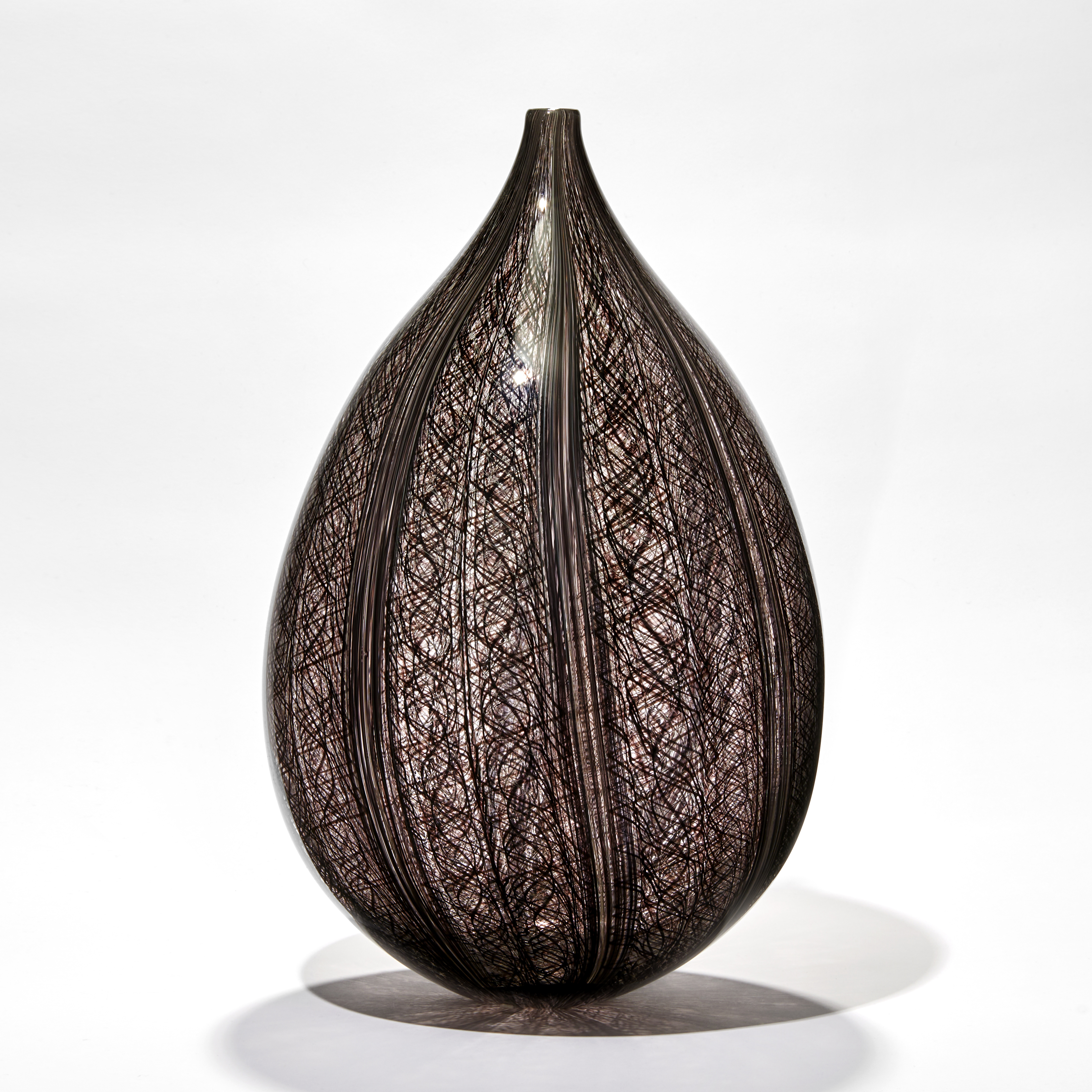 sculpted art-glass vase with wide base and narrow top with patterned exerior 