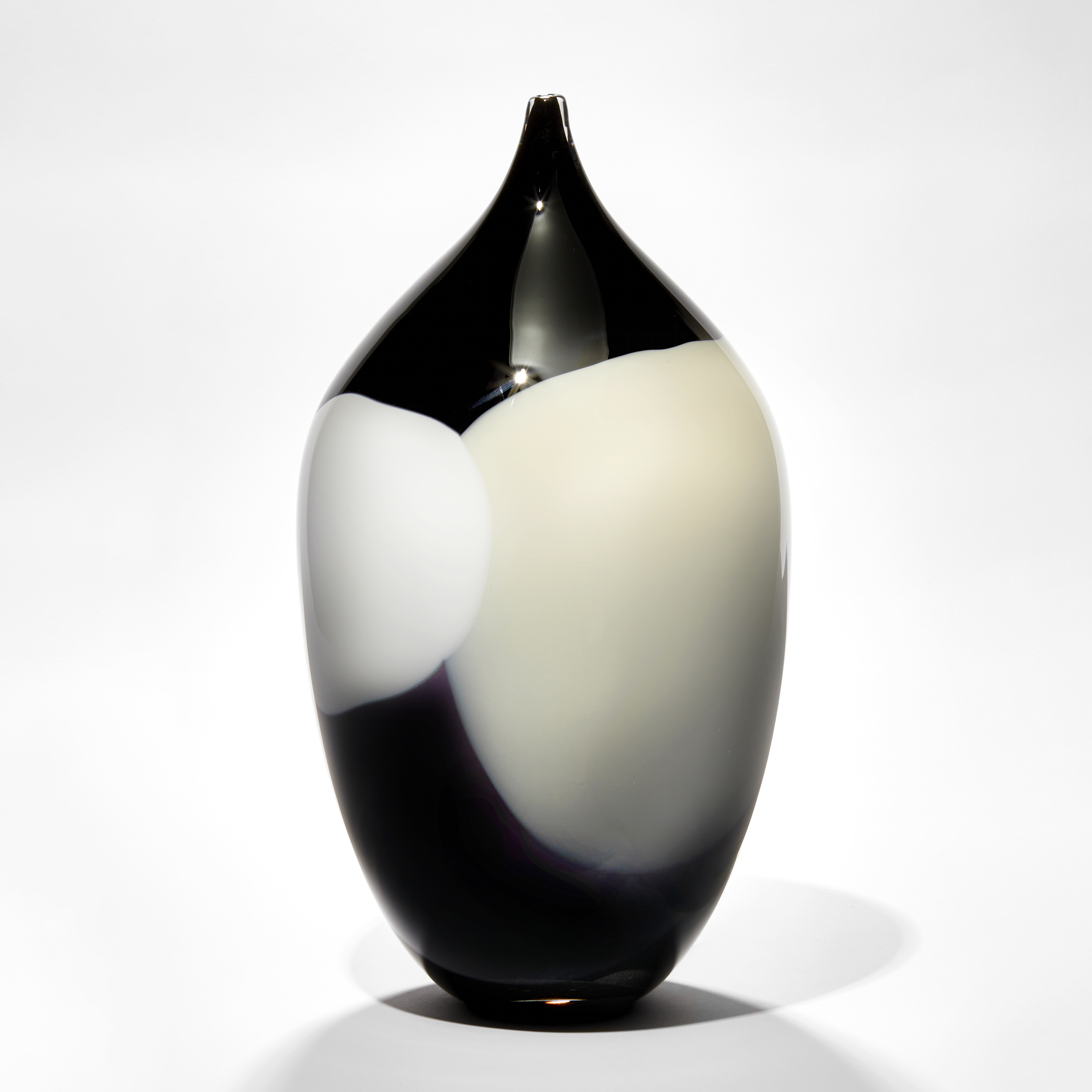 rounded tall oval bottle sculpture with long narrow pointed neck with abstract blob pattern like a rothko painting in black white and cream hand blown from glass