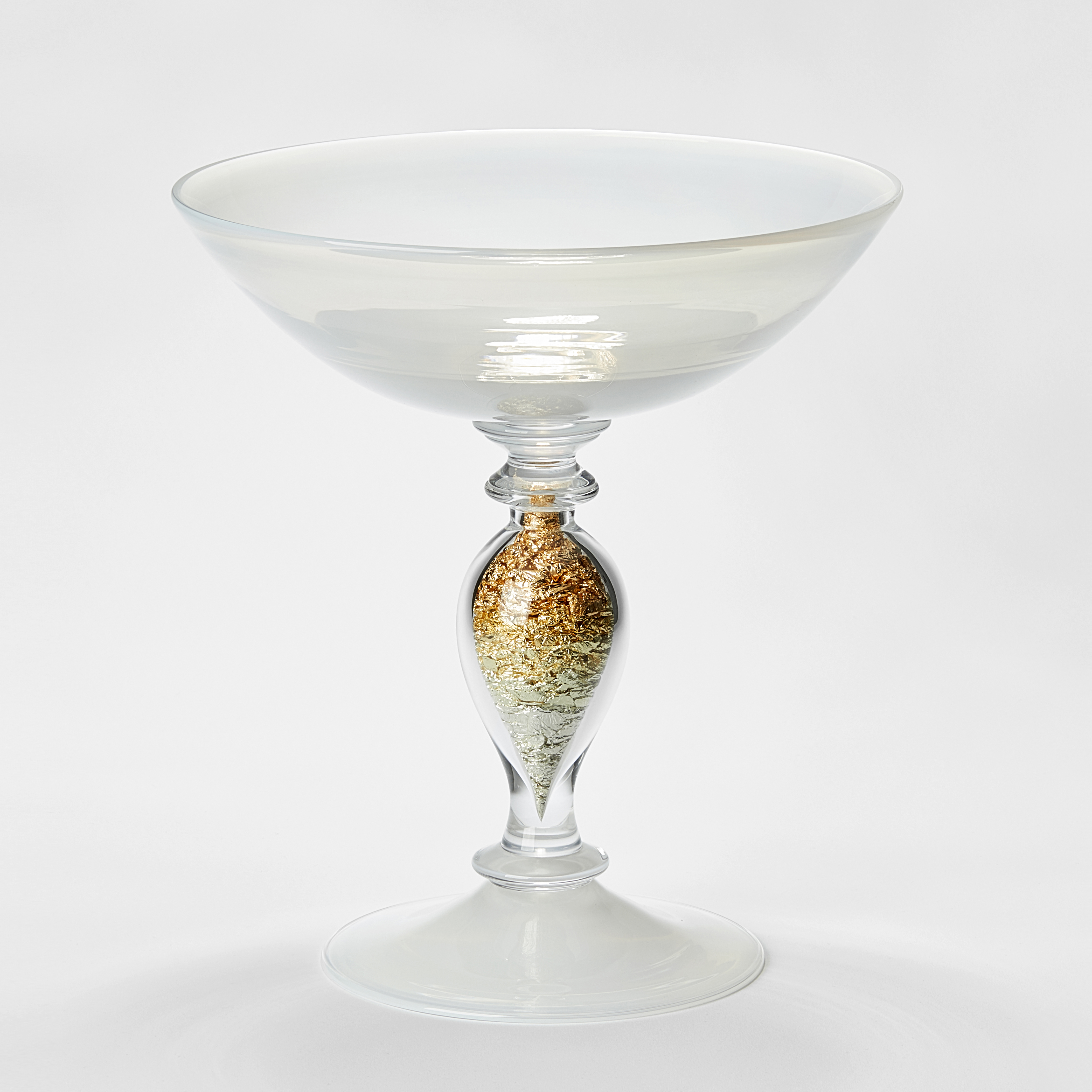 handblown traditional venetian style centre piece with detailed stem and flared bowl on top in clear and white glass with the undulating central stem filled with gold leaf 