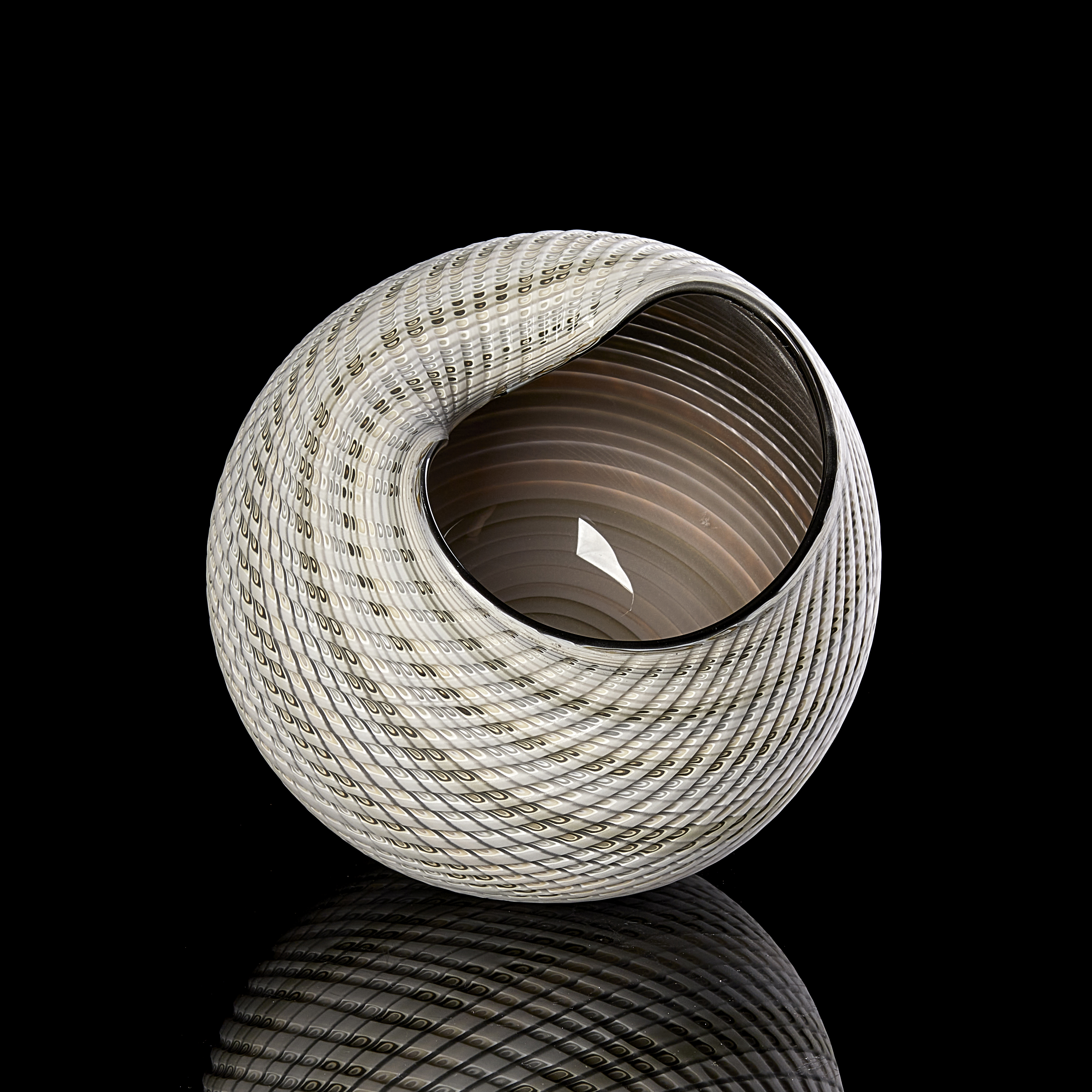 round shell like vessel with shiny bronze brown interior and textured light coloured cut exterior with bands of colour in grey off white soft blue and green hand made from glass