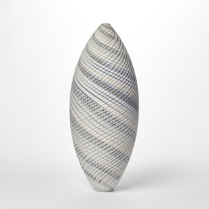 tall standing ovoid vessel with small opening at the top and curling lines round the form in white grey and soft blue with textured cut surface hand made from glass