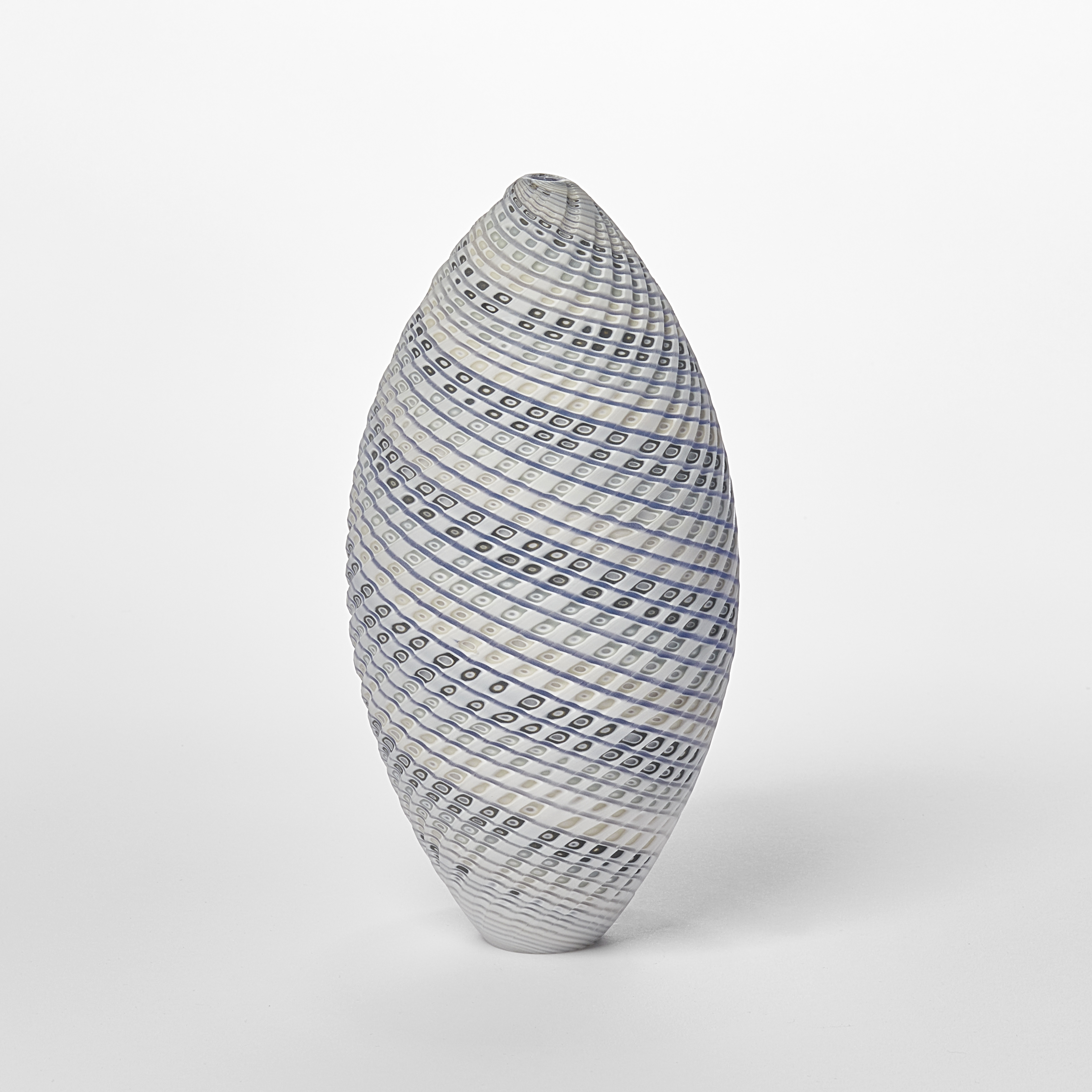pointed standing ovoid shaped vessel with banded coloured and cut lines in white cream blue and grey twisting round the from hand made from glass
