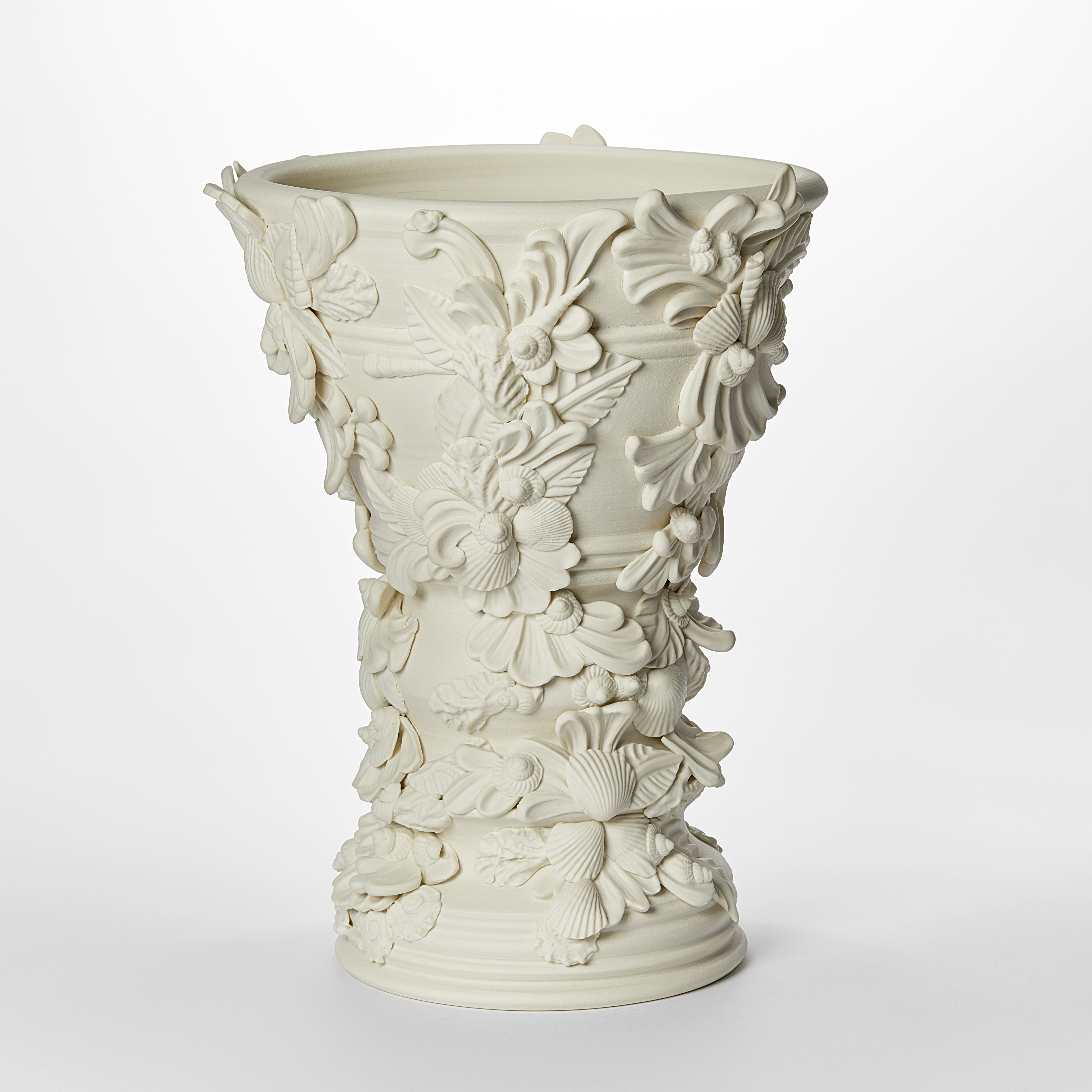 flared off white light cream alabaster vase covered in shells and architectural flourishes hand made from porcelain