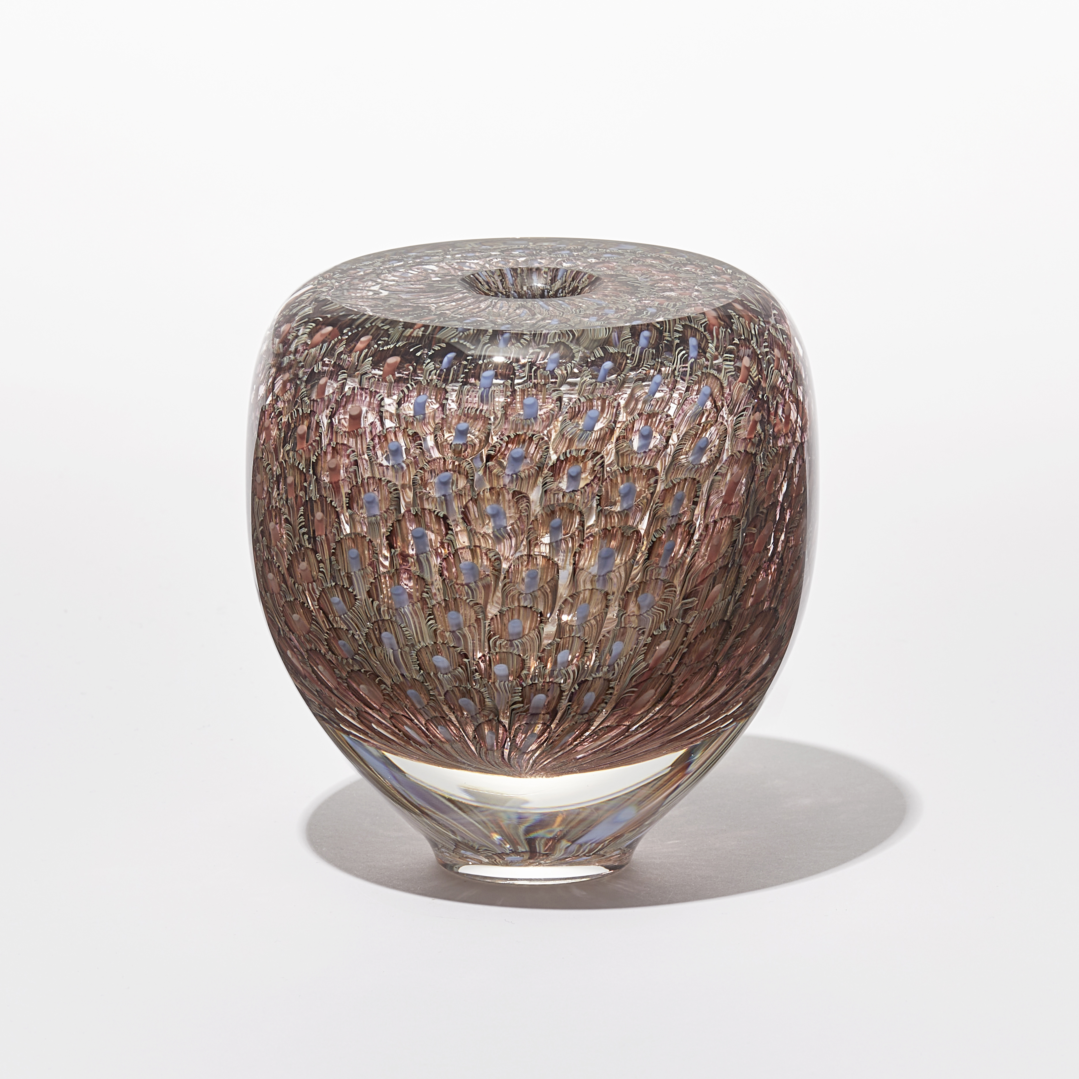 transparent round vessel with flat top and small opening with intense fine repeating murrine pattern in coral salmon aubergine and blue hand made from glass