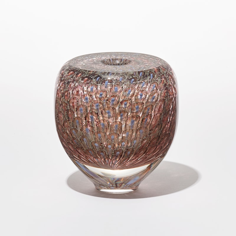 transparent round vessel with flat top and small opening with intense fine repeating murrine pattern in coral salmon aubergine and blue hand made from glass