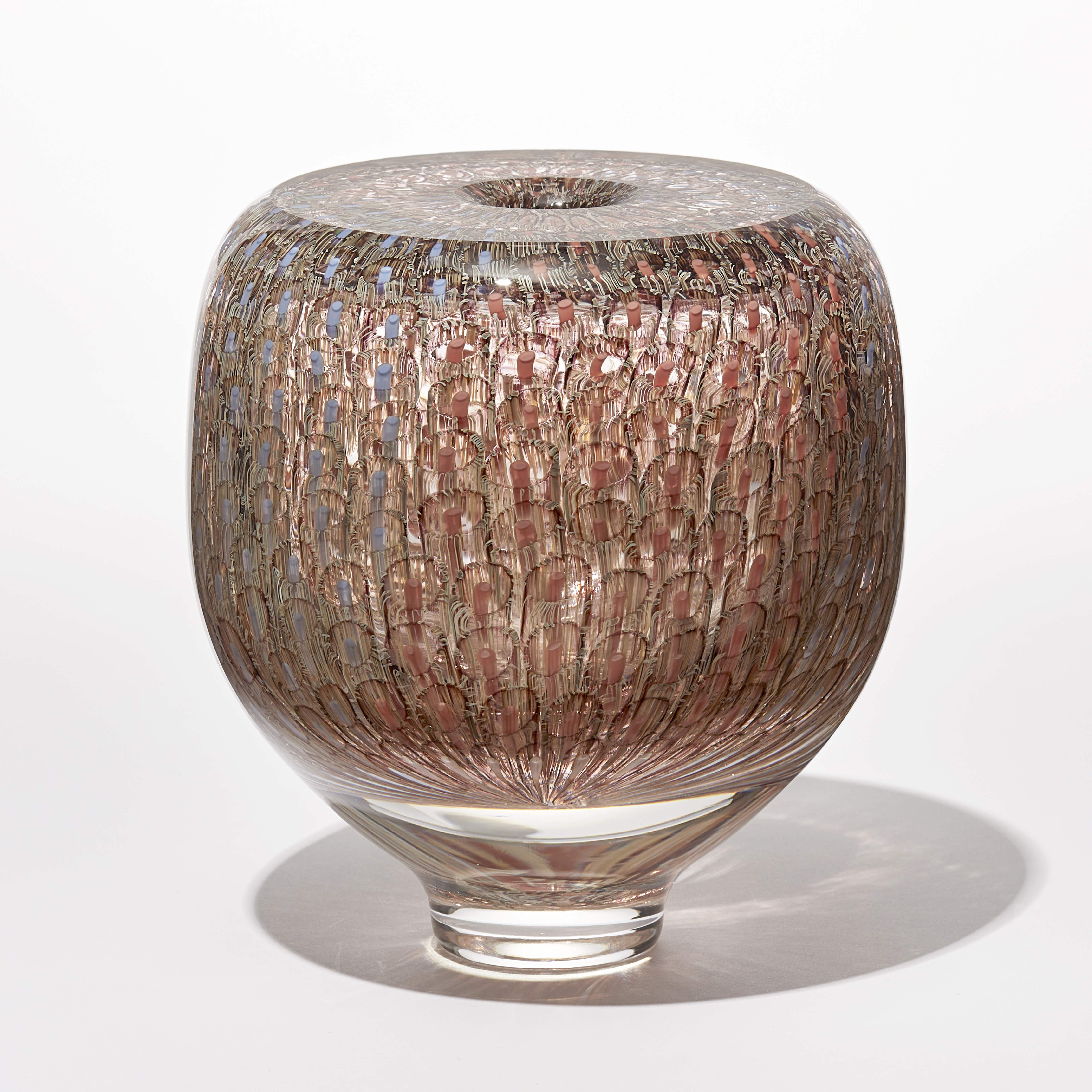 shiny transparent heavy vase with flat top and small central aperture covered in a fine delicate organic repeat swirling line pattern in aubergine salmon coral and pale blue hand made from glass