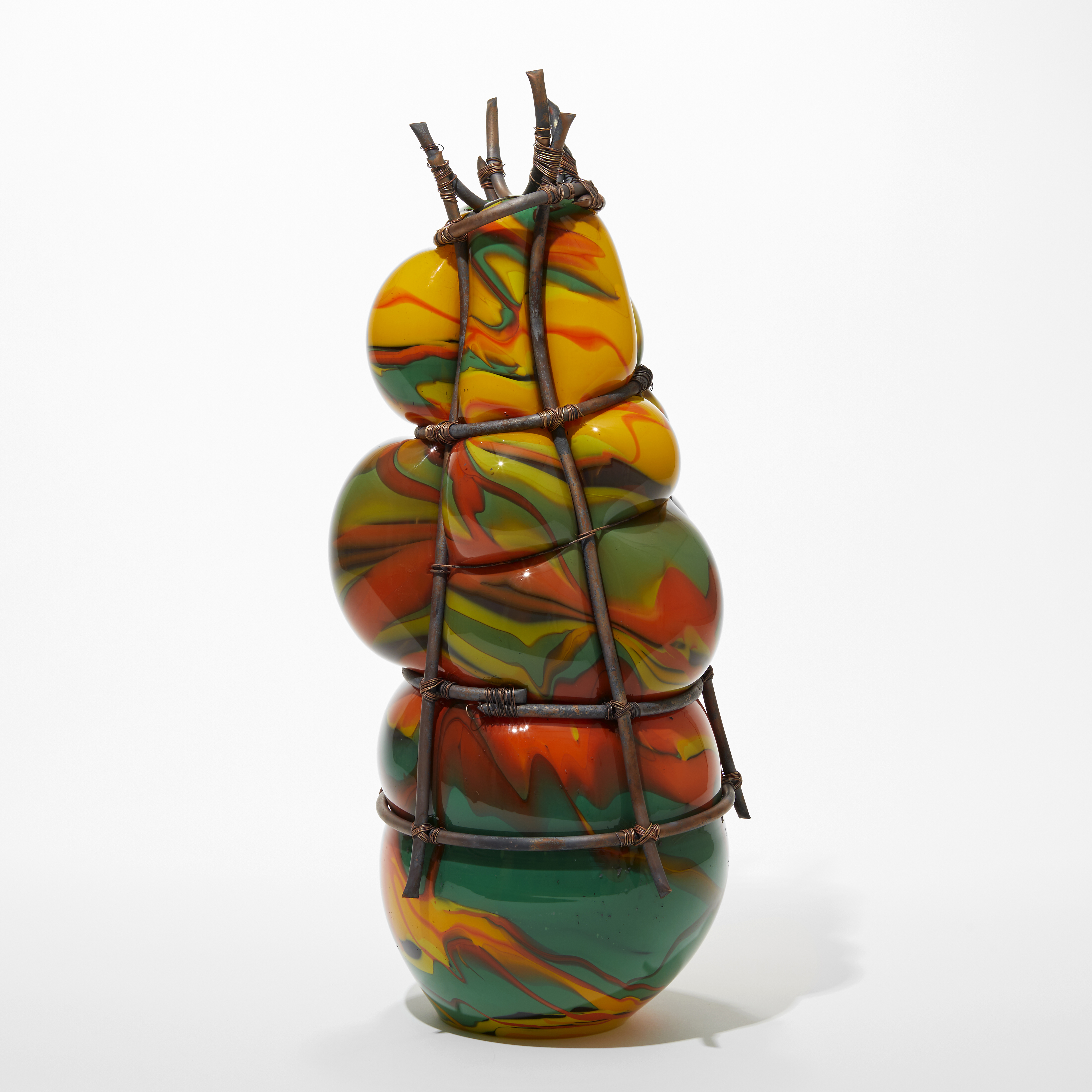 bound narrowing copper cage holding bulging glass in green yellow black and red handblown with copper piping