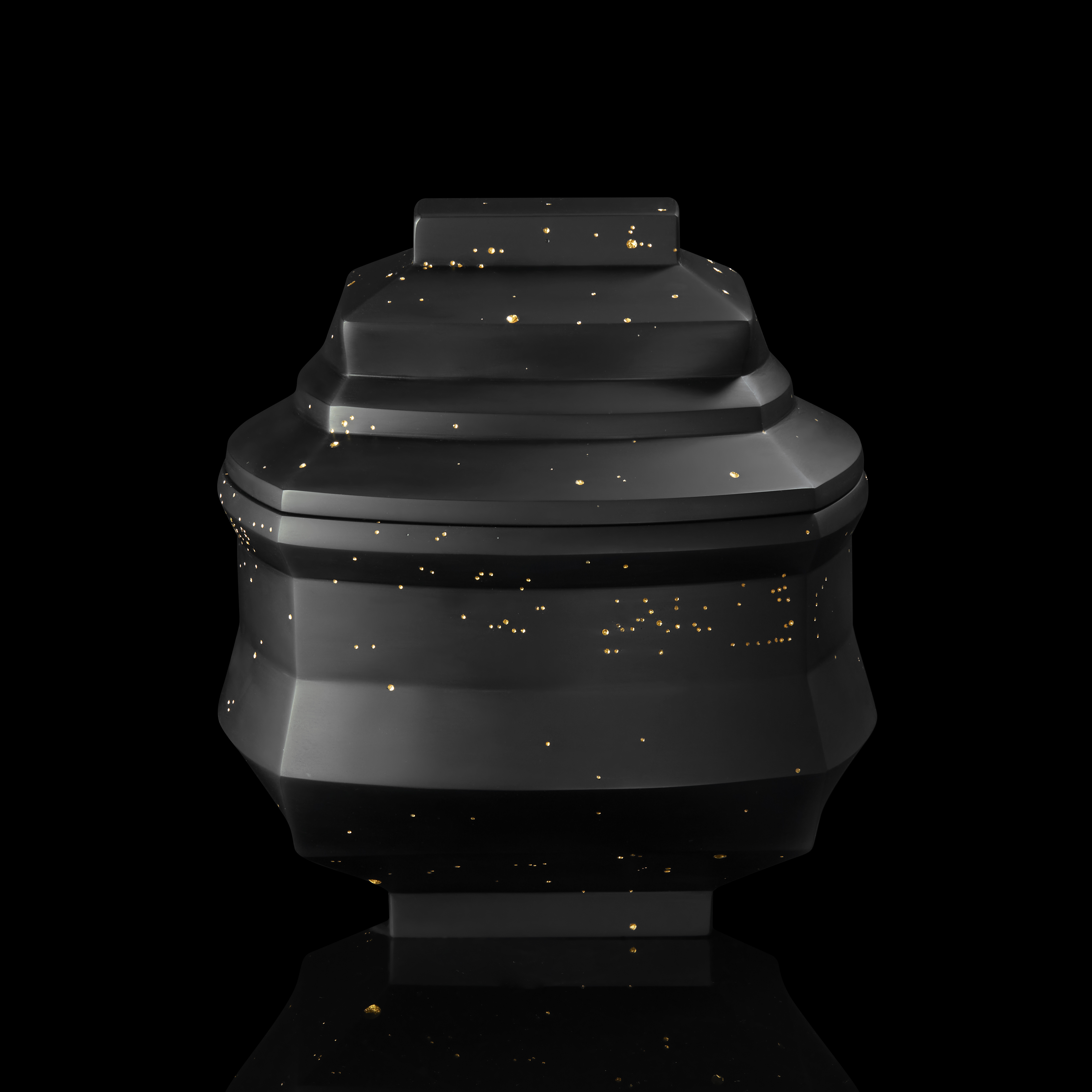 dense black box with facetted and angled sides and lid with randomly arranged recessed small holes all over the surface filled with 23.5 carat gold hand made from cast glass