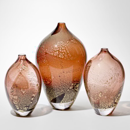 art glass sculptural vases in amber and aubergine with gold leaf-shaped speckles on exterior