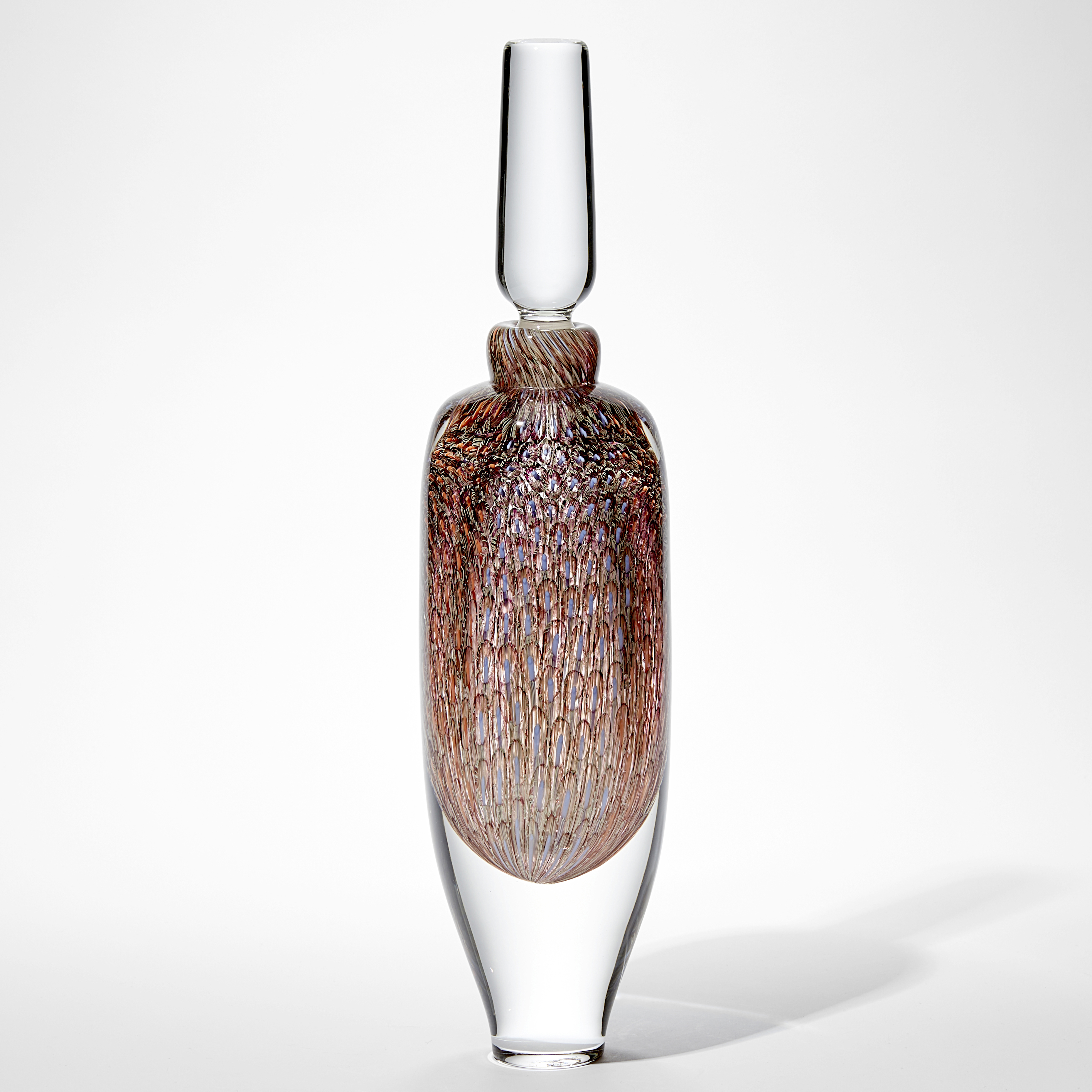 tall clear glass bottle with clear stopper and tapered clear base with trapped internally intense detailed repeat pattern in pale blue coral and soft orange