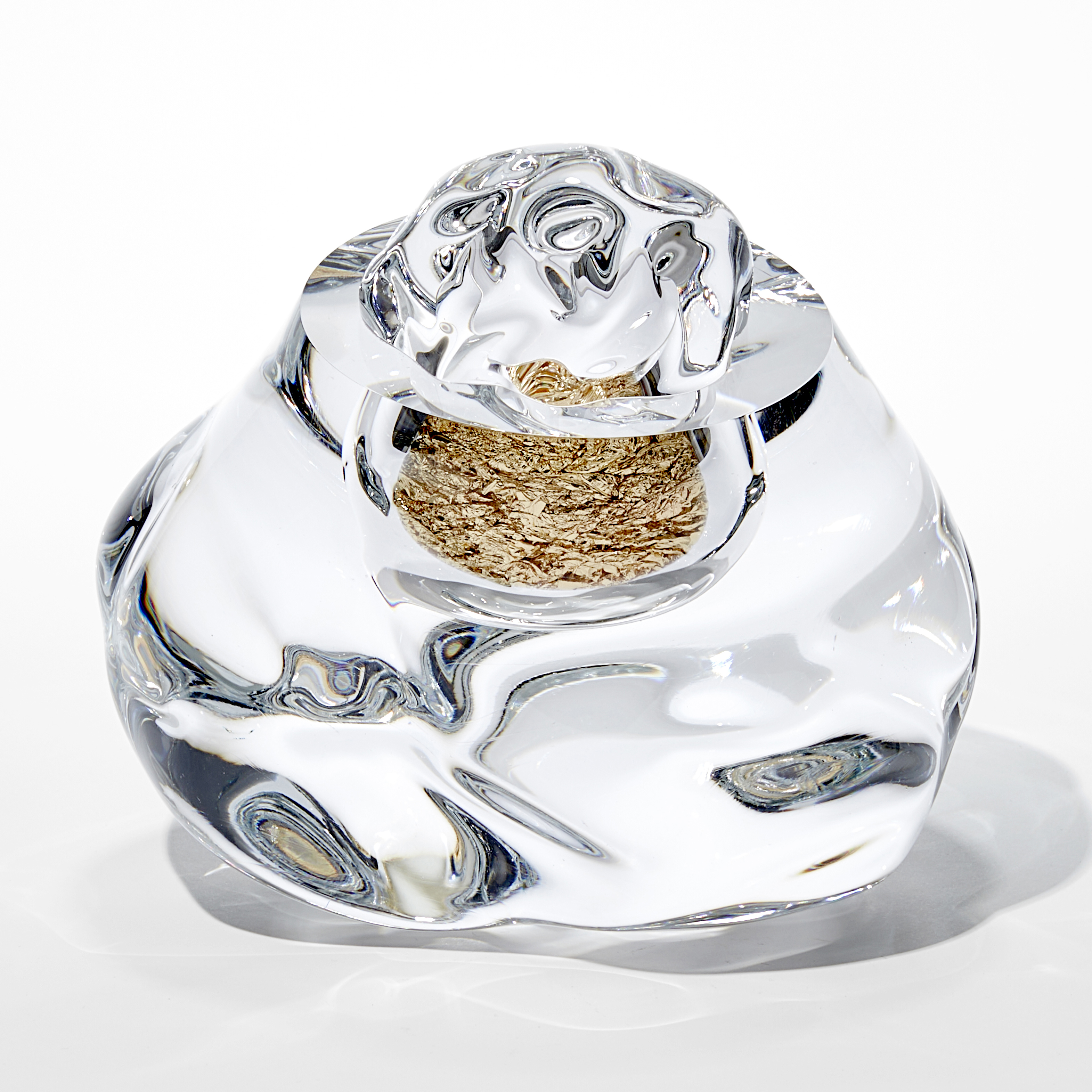 organic amorphous clear mass with internal hallow filled with crumpled gold leaf hand made from glass