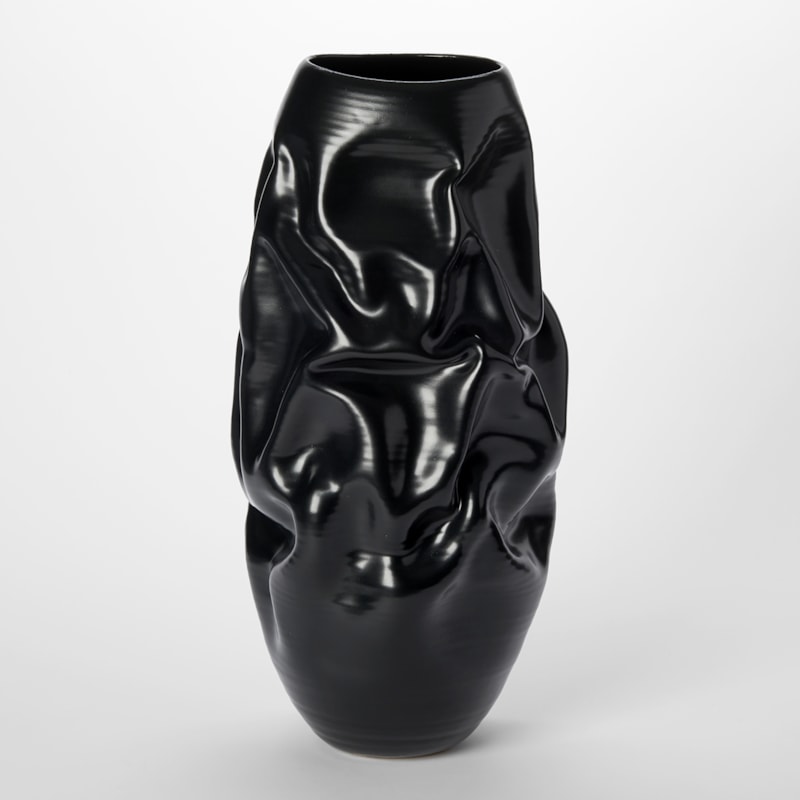 tall satin black crumpled and wrinkled abstract vessel with distinct surface lines and crevasses hand made and thrown from clay