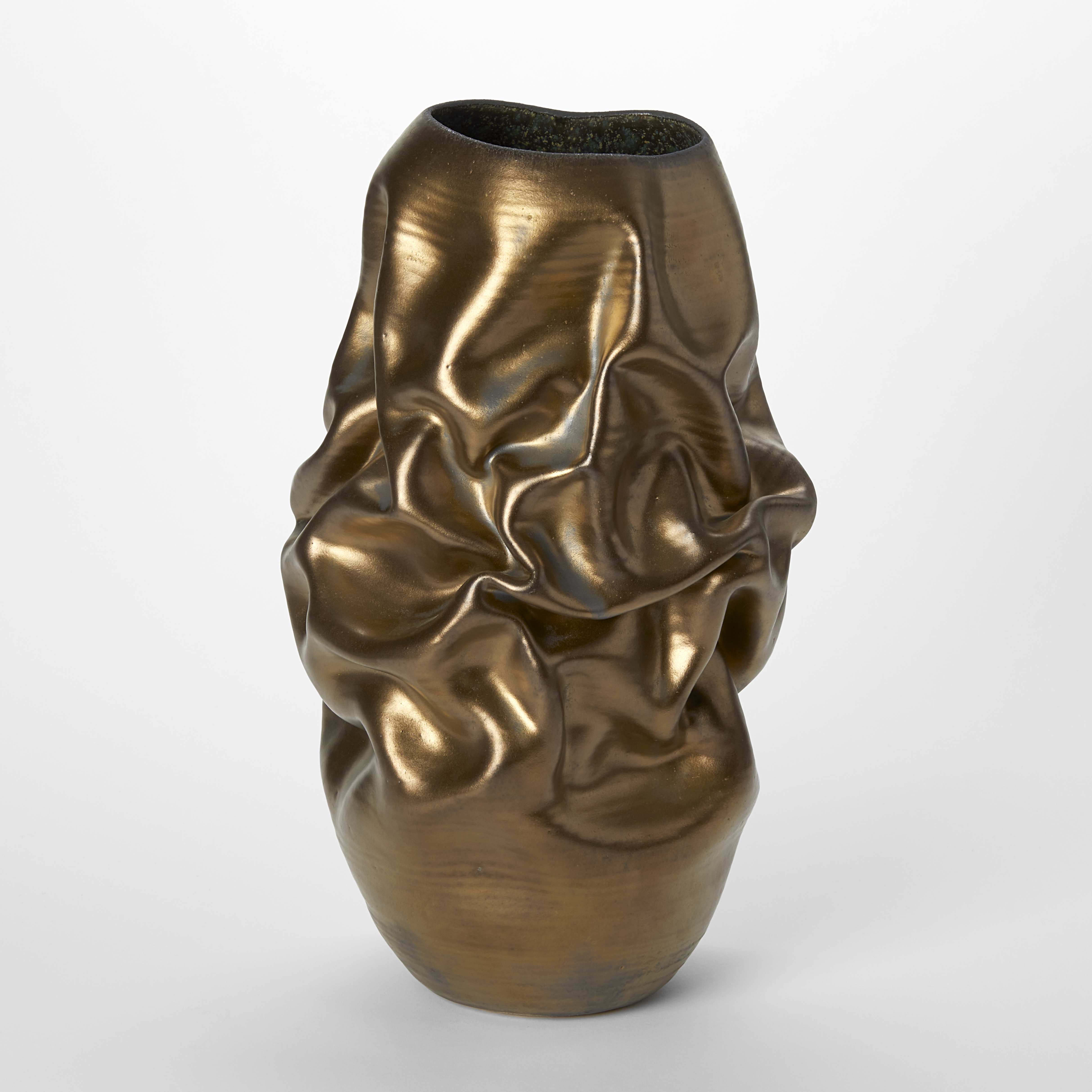 tall crumpled and wrinkled weathered bronze gold coloured vessel with rich dark turquoise green and blue speckled interior and made from glazed white st thomas clay