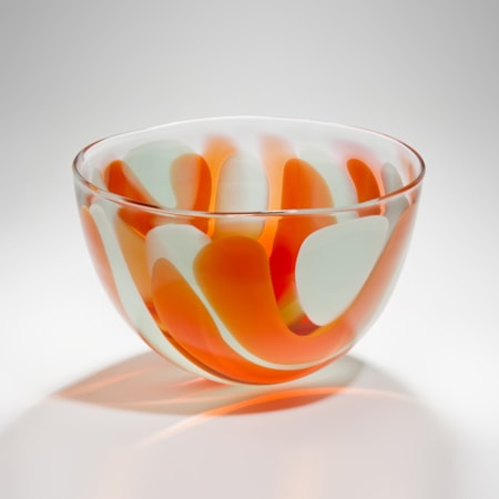 small bowl glass sculpture with orange and white swirls resembling colours of an egg