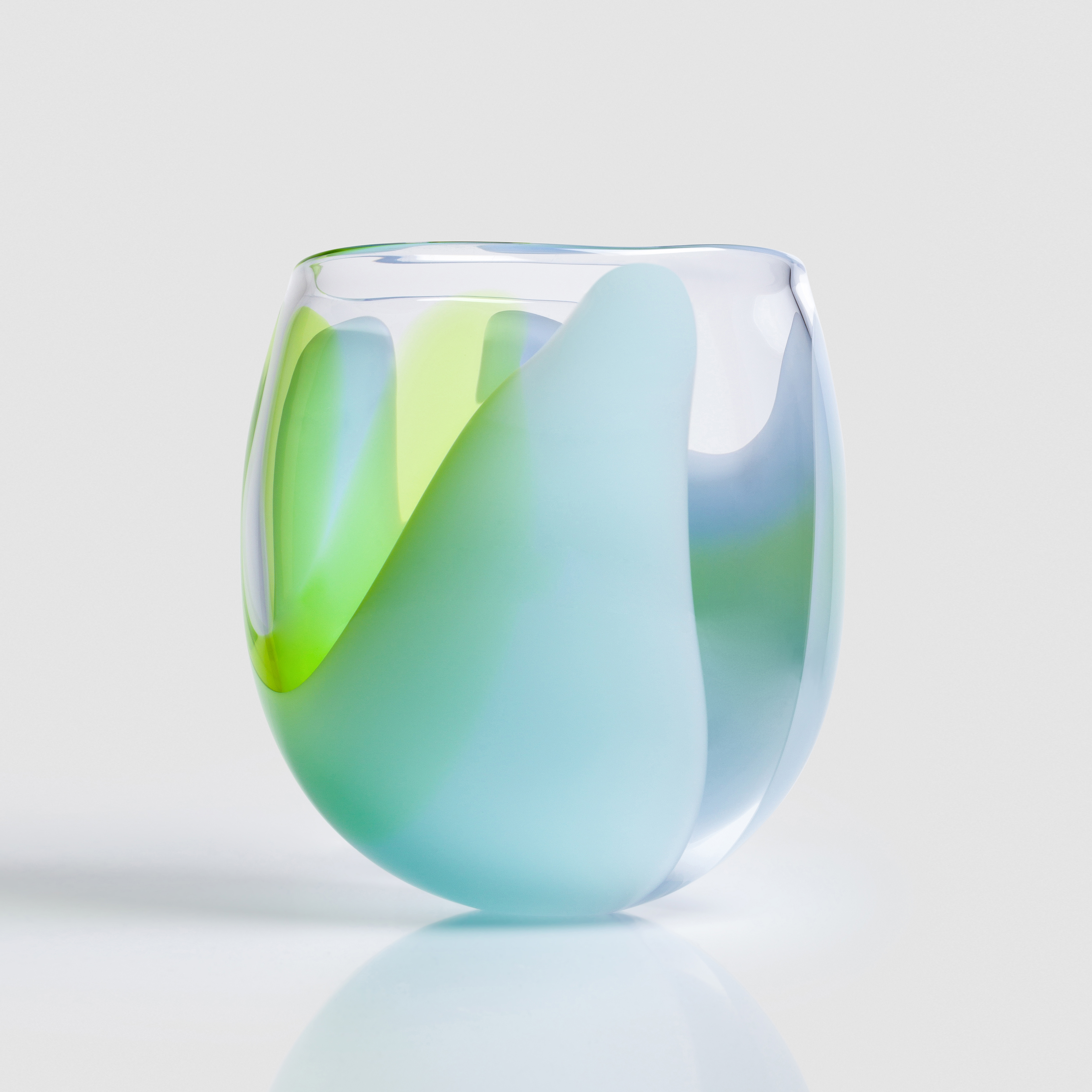 tulip bud shaped clear hand blown glass bowl with soft abstract sections of colour in opaque lime green blue and light blue