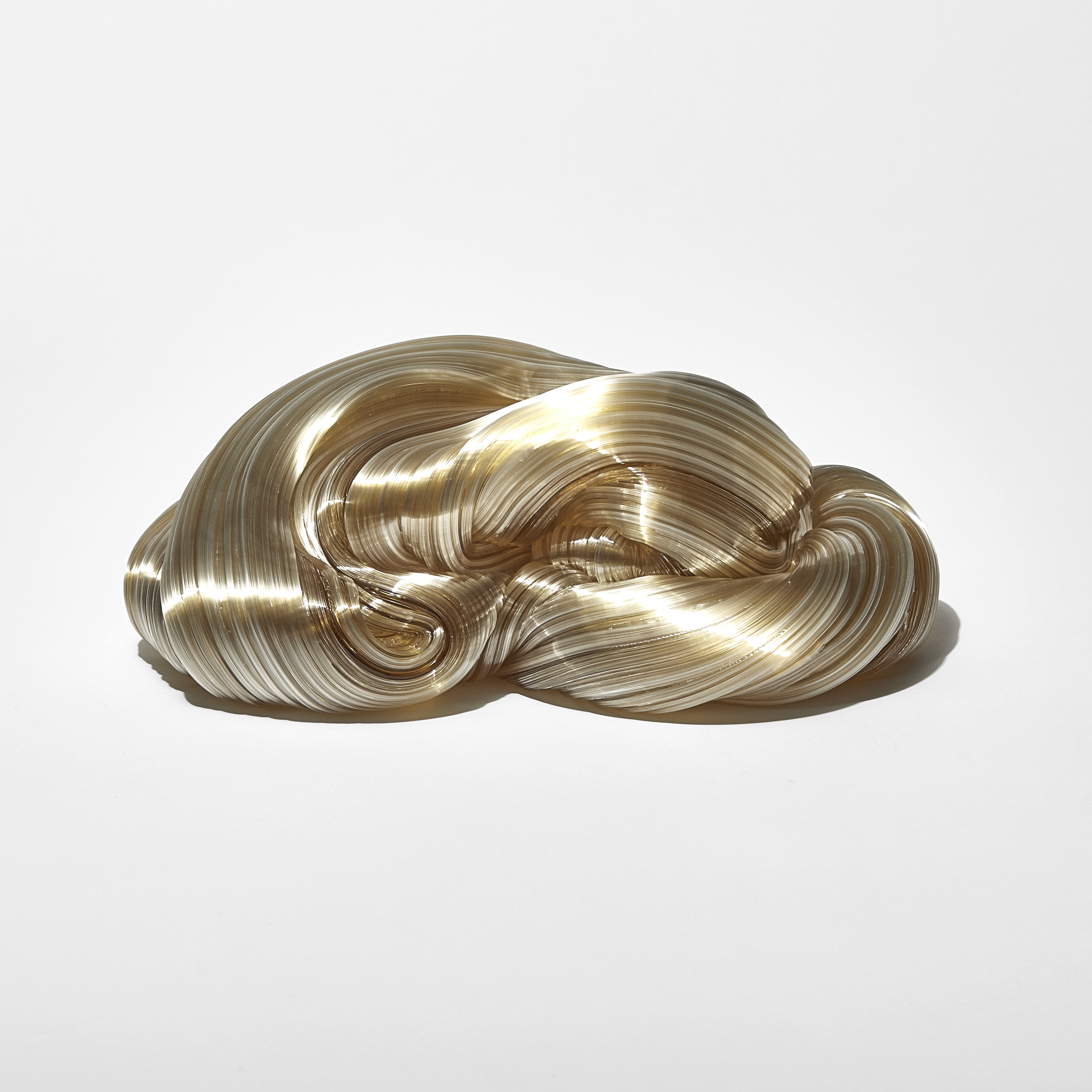 ridged glistening twisting piled candy cane mass in soft amber colour handmade from glass