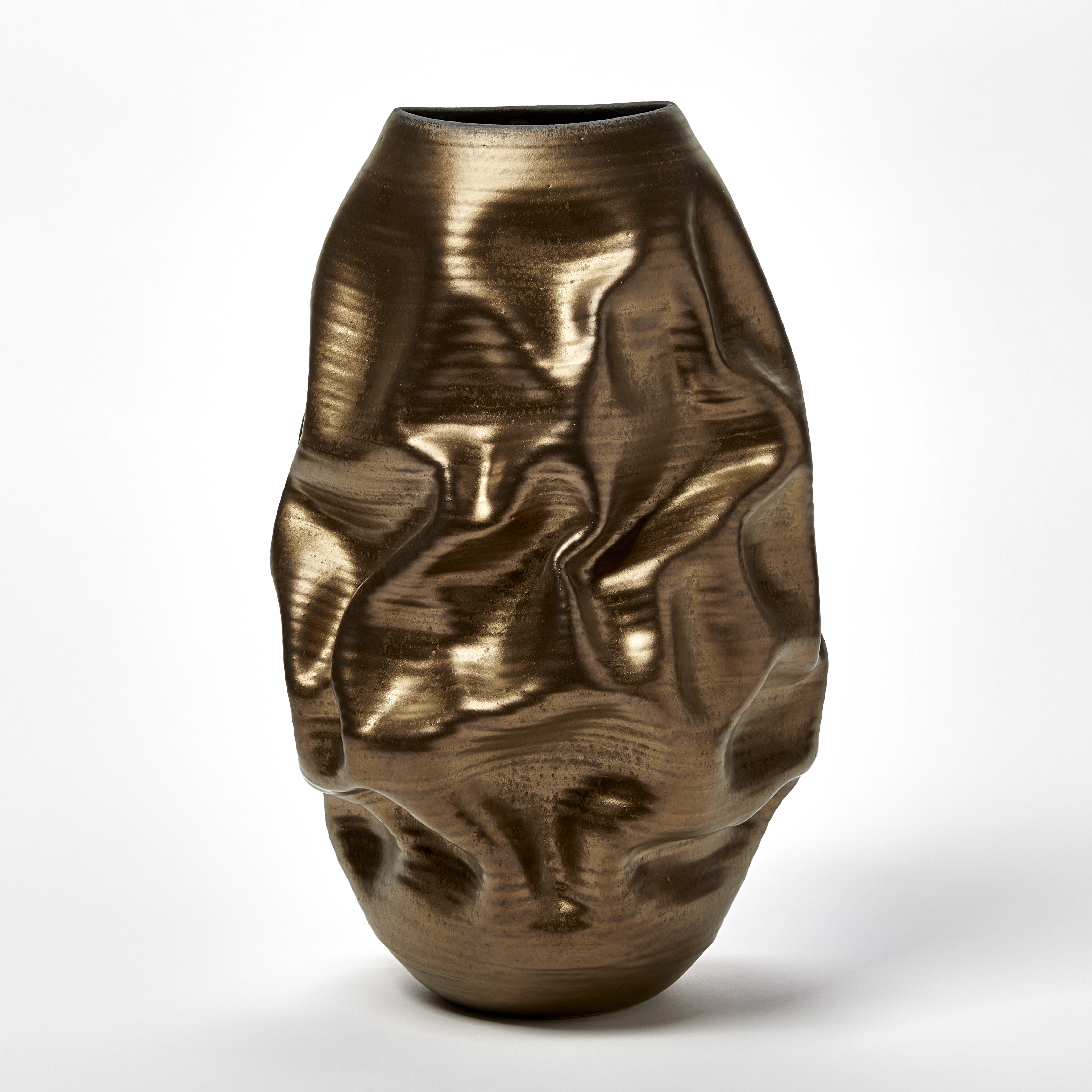 bronze gold crunched wrinkled and ridged oval standing vase with oval opening and blue starburst pattern inside handmade from ceramic