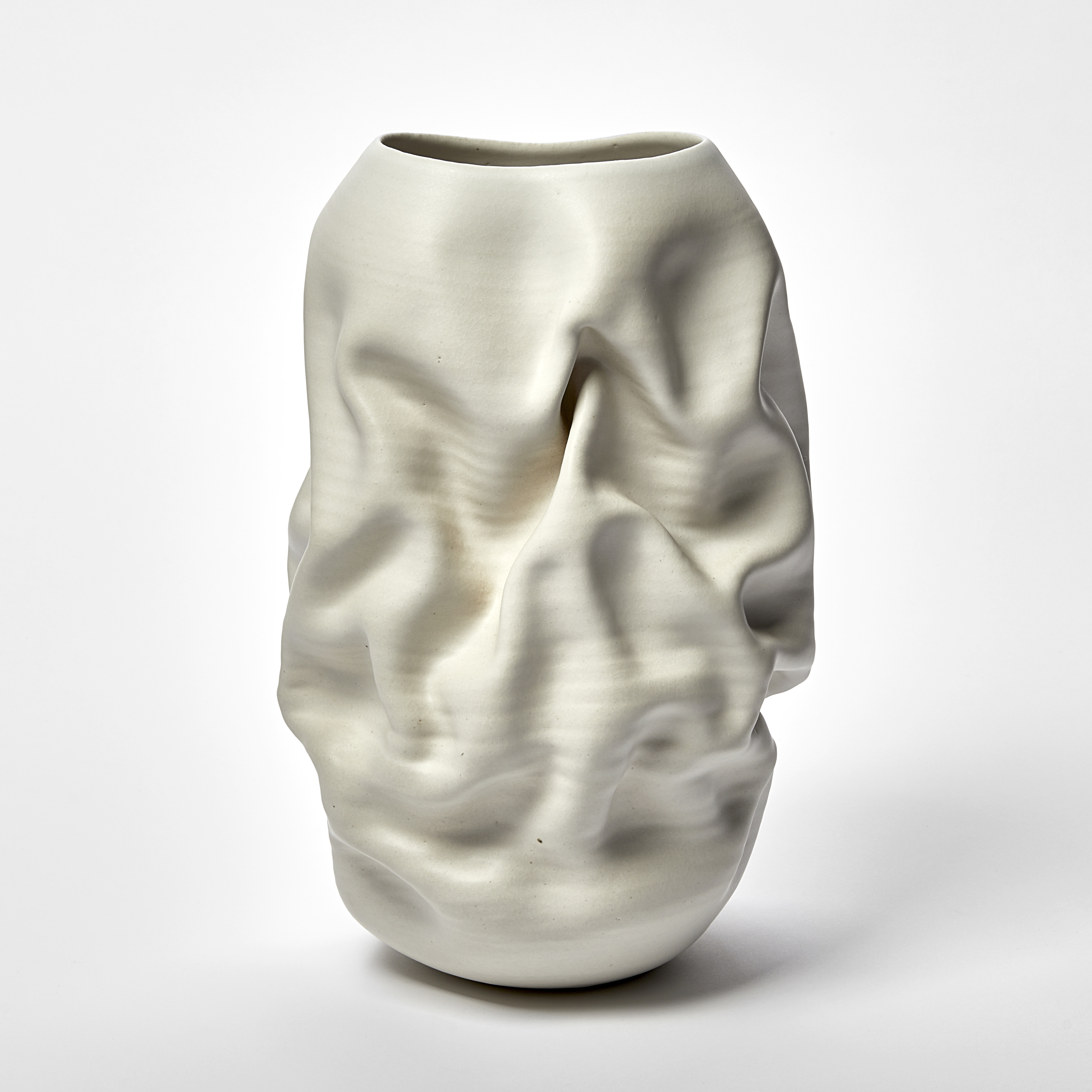 white standing wrinkled and ridged tall vase with oval top opening hand made from clay