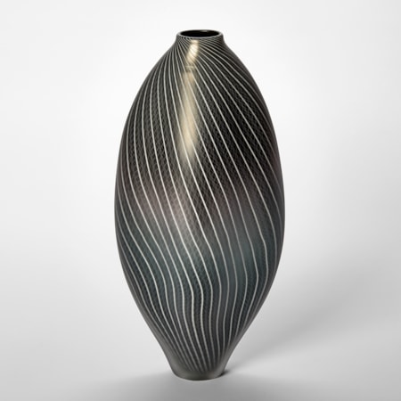 black and pewter amorphic shaped vessel with small top opening and fine white line lace like pattern covering the surface hand made from glass