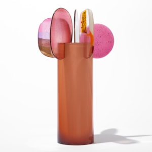 opaque orange cylinder with five rounded finials overlapping and perched on the top edge with abstract patterns in pink gold white and clear hand made from blown and fused glass