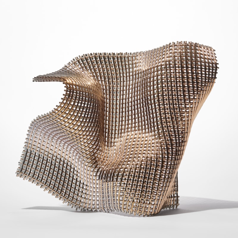 standing undulating glass sculpture with the appearance of open woven cloth with one side covered in gold hand made from fused find glass canes