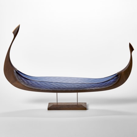 dark oak and opaque cut blue glass hulled viking ship with repeat cut texture pattern hand made and presented on a stainless steel and wooden base