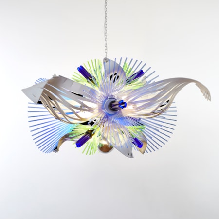 hanging sculptural light in white blue and green which resembles alien botany a vibrant mix of graphic repetitive organic three dimensional shapes with cutout sections and fronds made from acrylic with ultraviolet lightbulbs