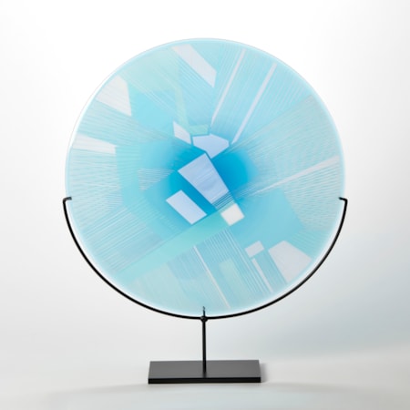 turquoise and blue etched glass plate with raised graphic abstract pattern on a black metal base
