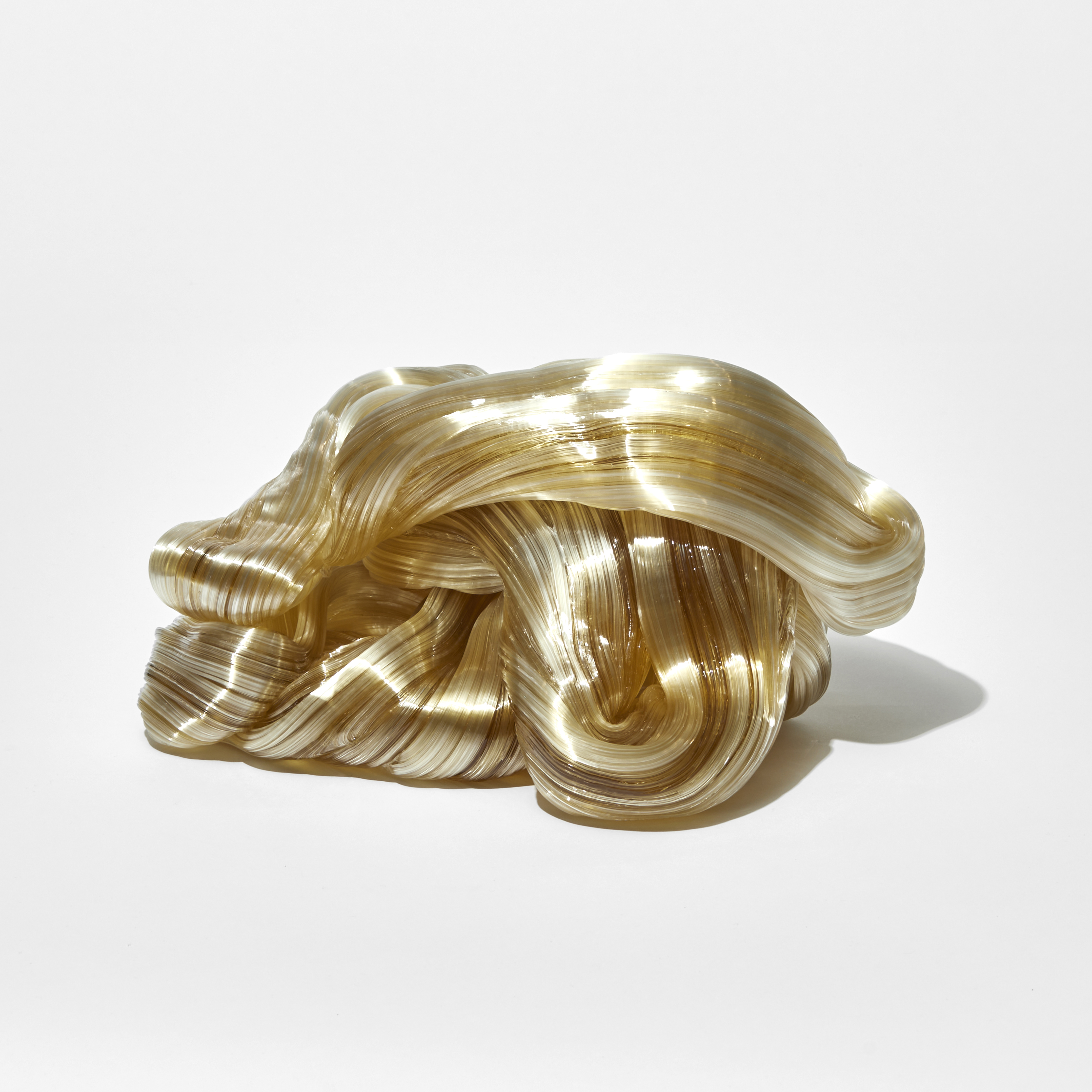 piled lopping chunky mass of soft golden amber coloured glass created from fine gathered canes hand made from glass