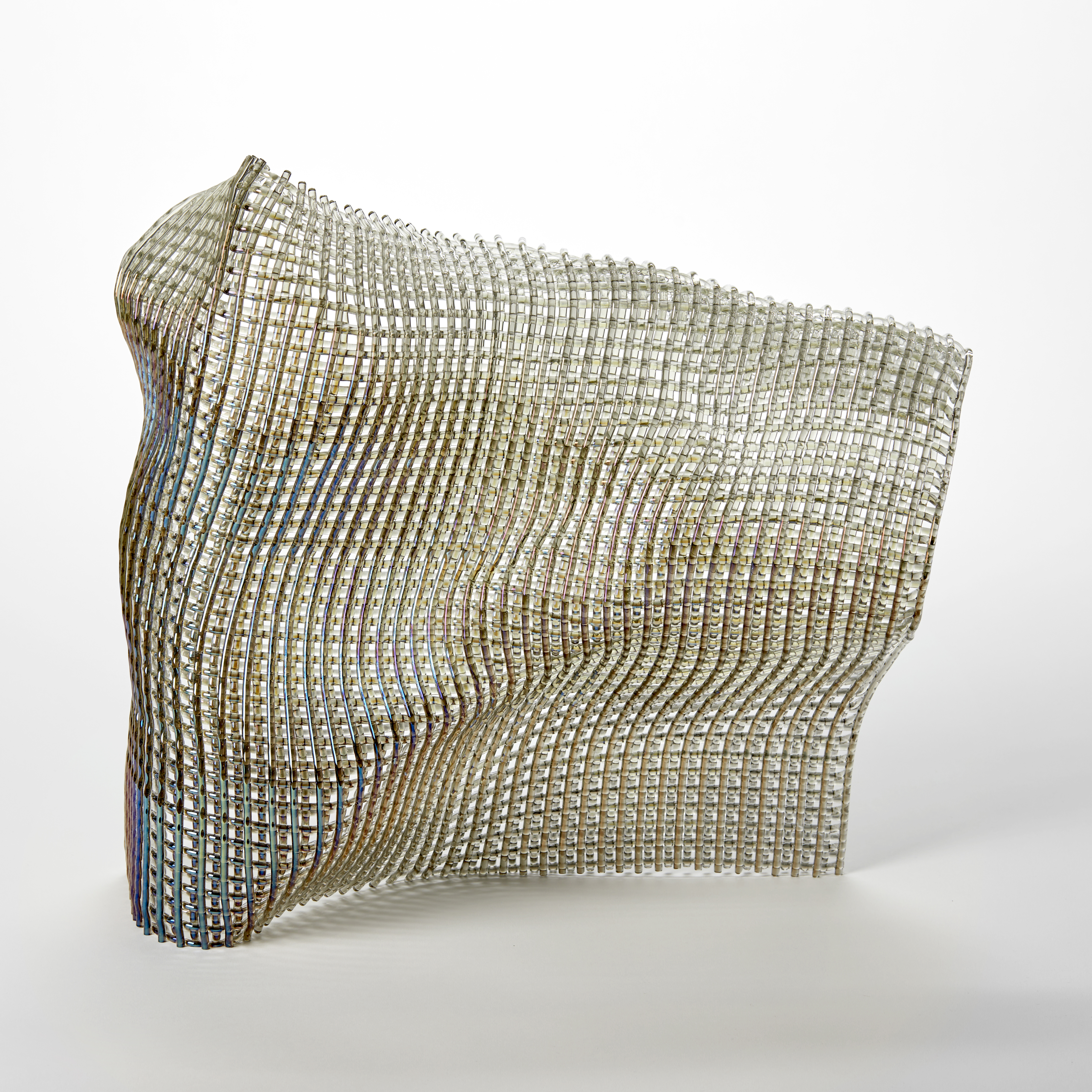 standing abstract glass sculpture with the appearance as if made from woven fabric with the front surface with a shimmering iridescent finish
